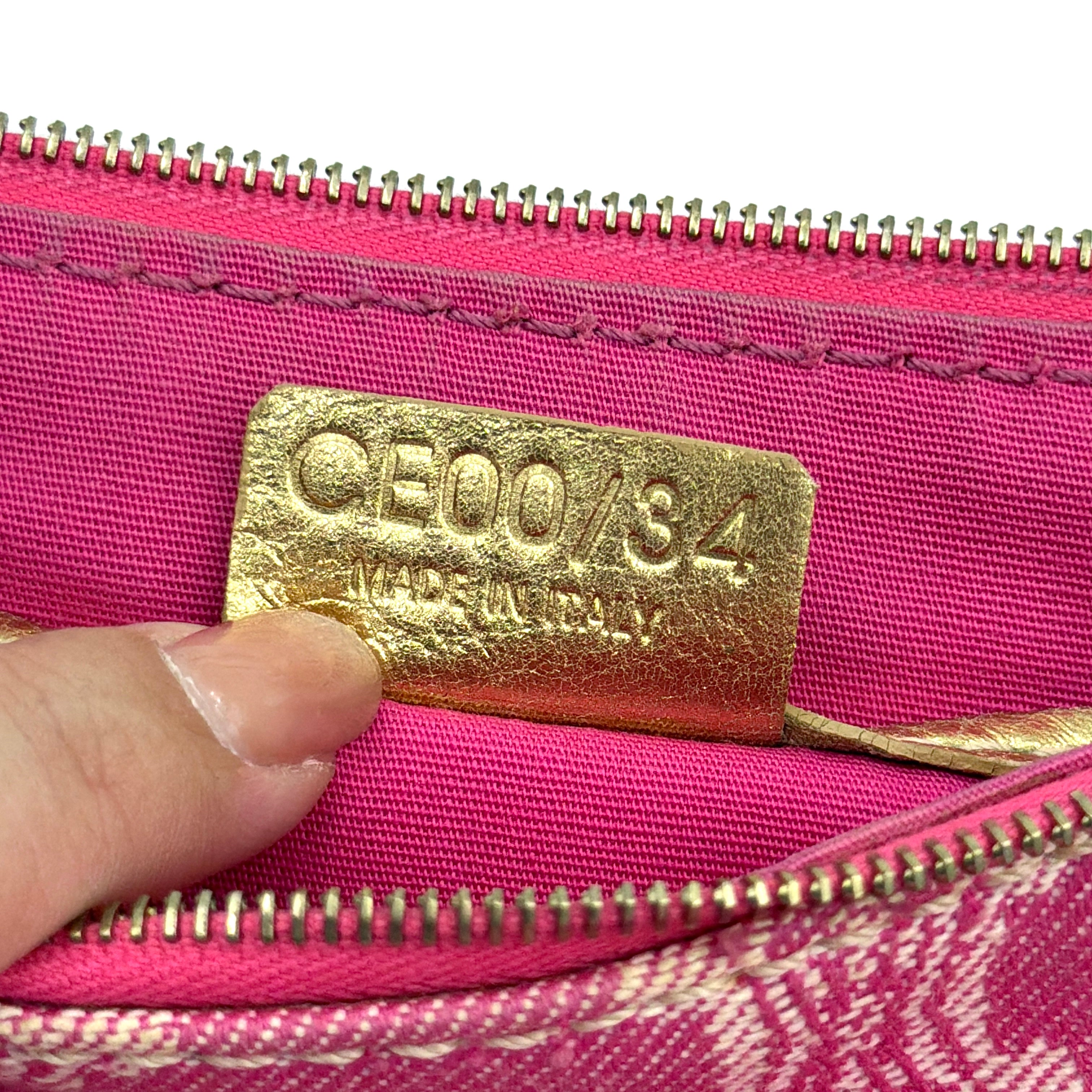 Front view of the Celine Macadam pink denim shoulder bag with gold-tone leather strap and triomphe monogram print.