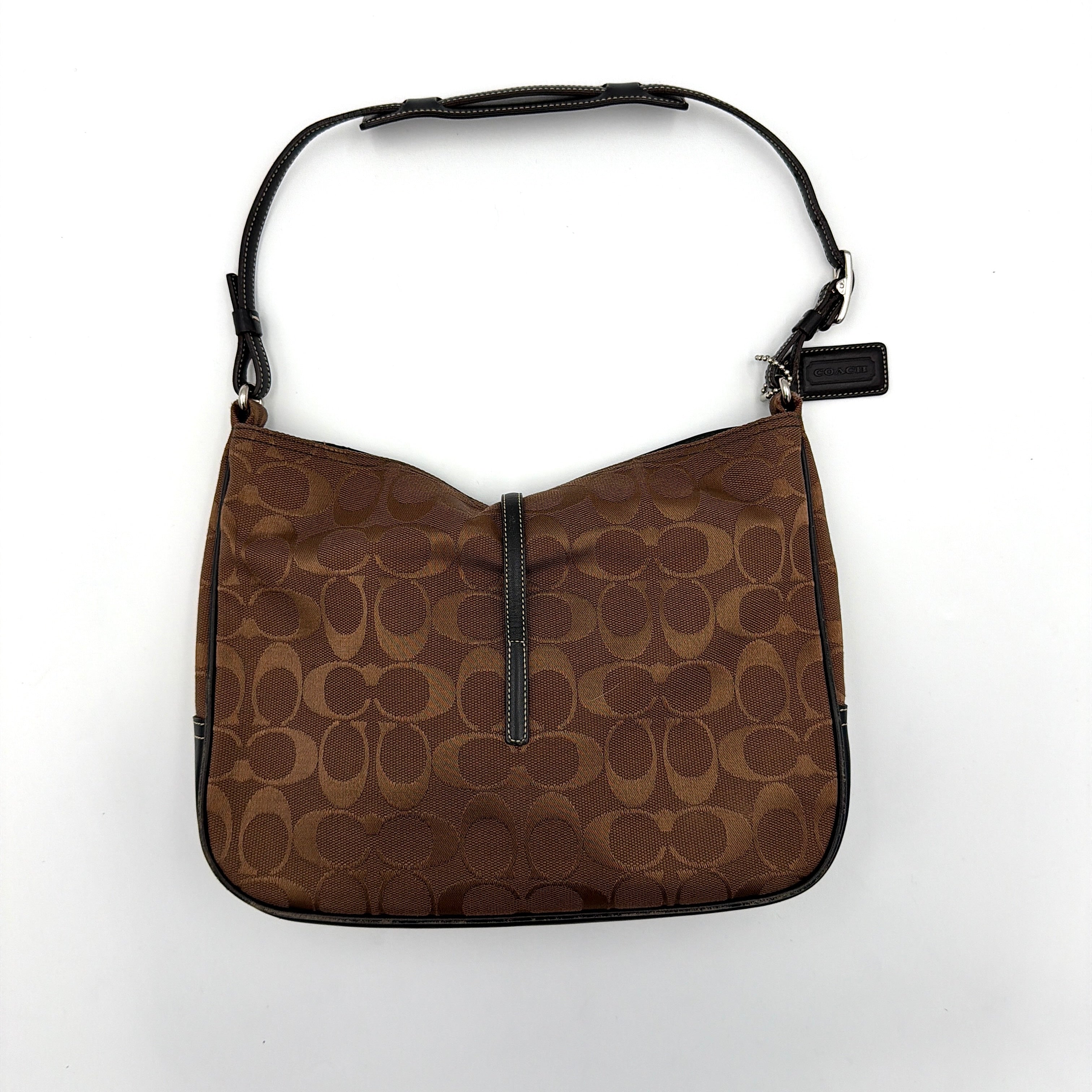 Coach Hobo Signature Clip canvas handbag in brown with black leather trim and silver hardware displayed against a plain background.