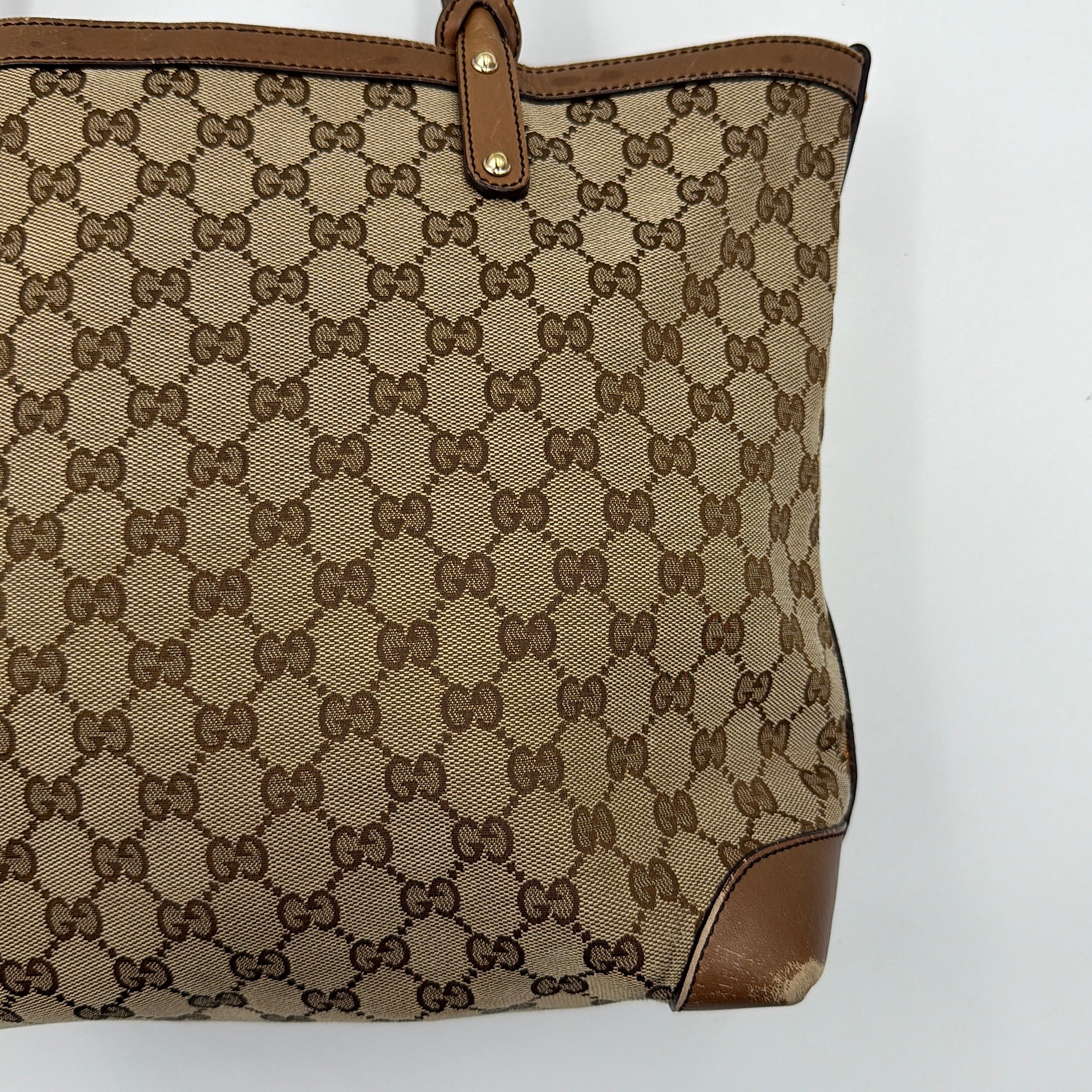 Gucci GG Monogram Craft Shoulder Bag in beige and brown canvas with double leather straps and matching logo-embossed leather pouch.