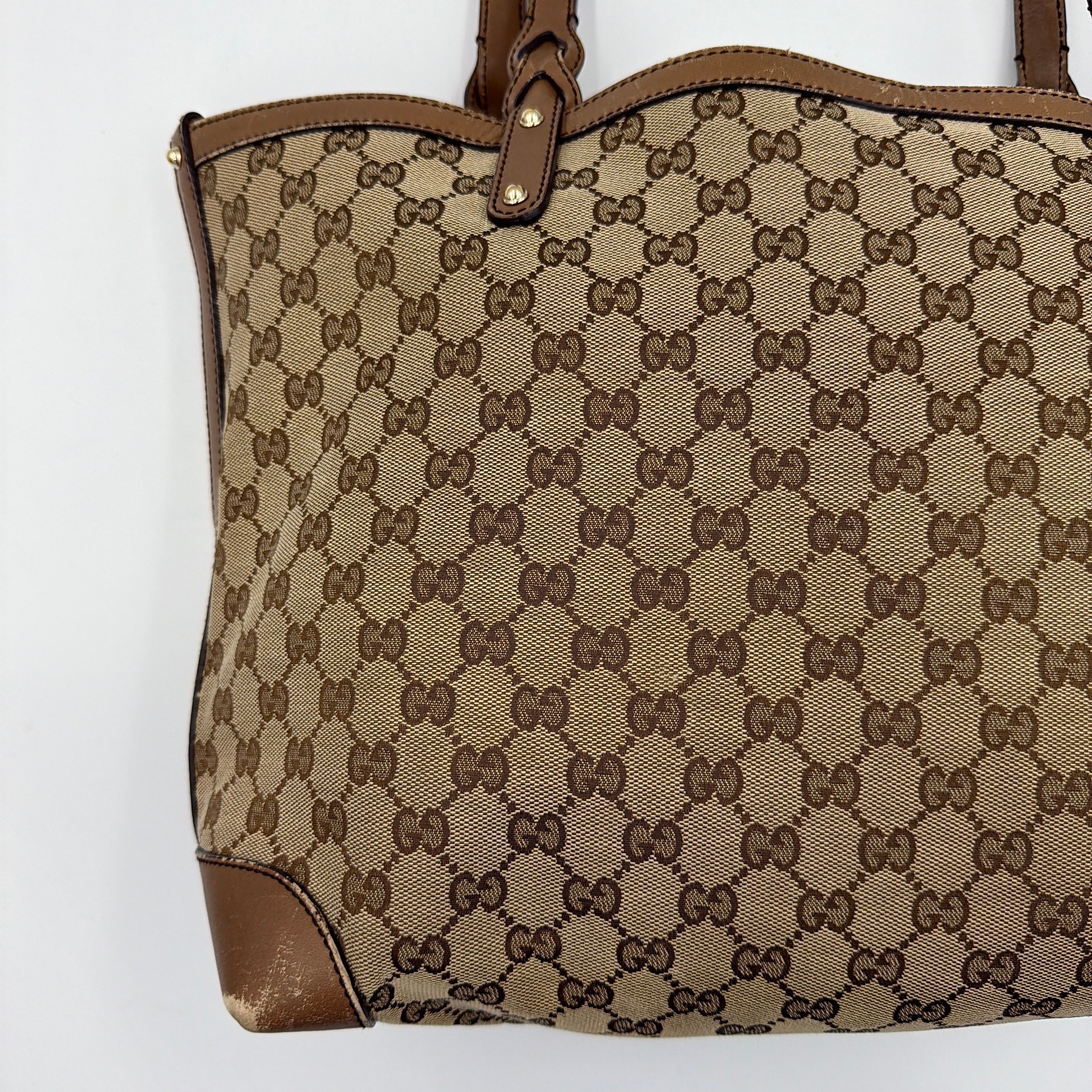 Gucci GG Monogram Craft Shoulder Bag in beige and brown canvas with double leather straps and matching logo-embossed leather pouch.