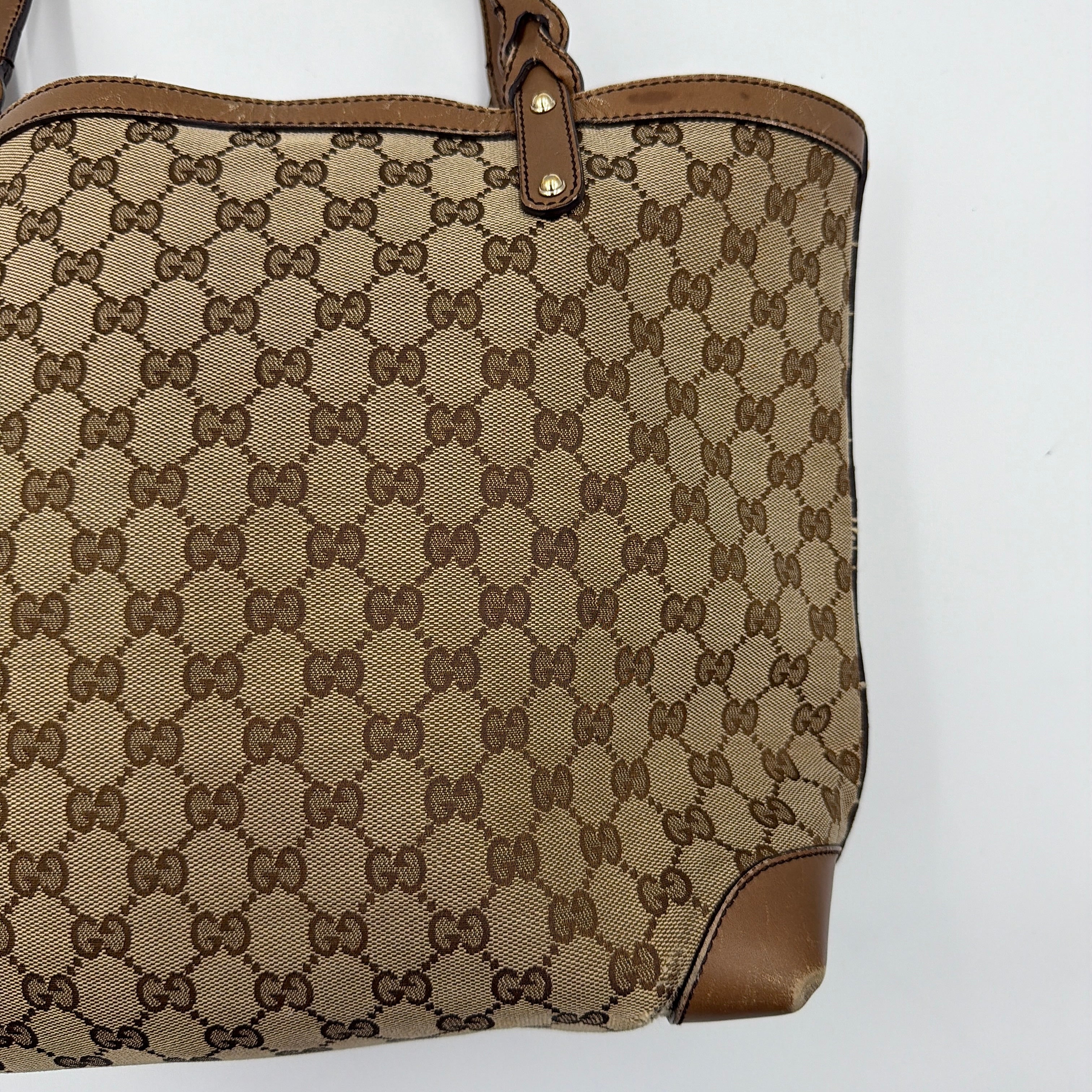 Gucci GG Monogram Craft Shoulder Bag in beige and brown canvas with double leather straps and matching logo-embossed leather pouch.
