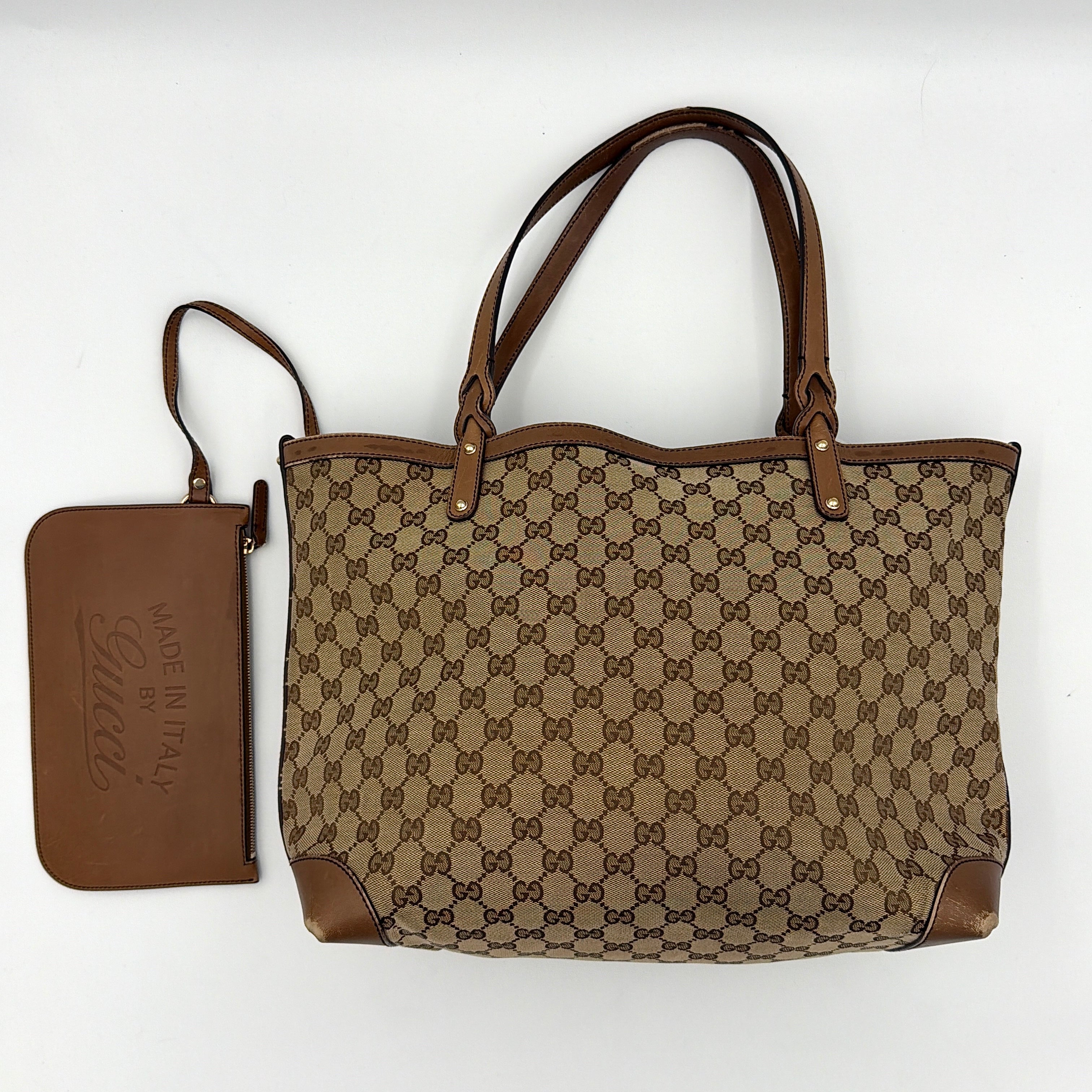 Gucci GG Monogram Craft Shoulder Bag in beige and brown canvas with double leather straps and matching logo-embossed leather pouch.