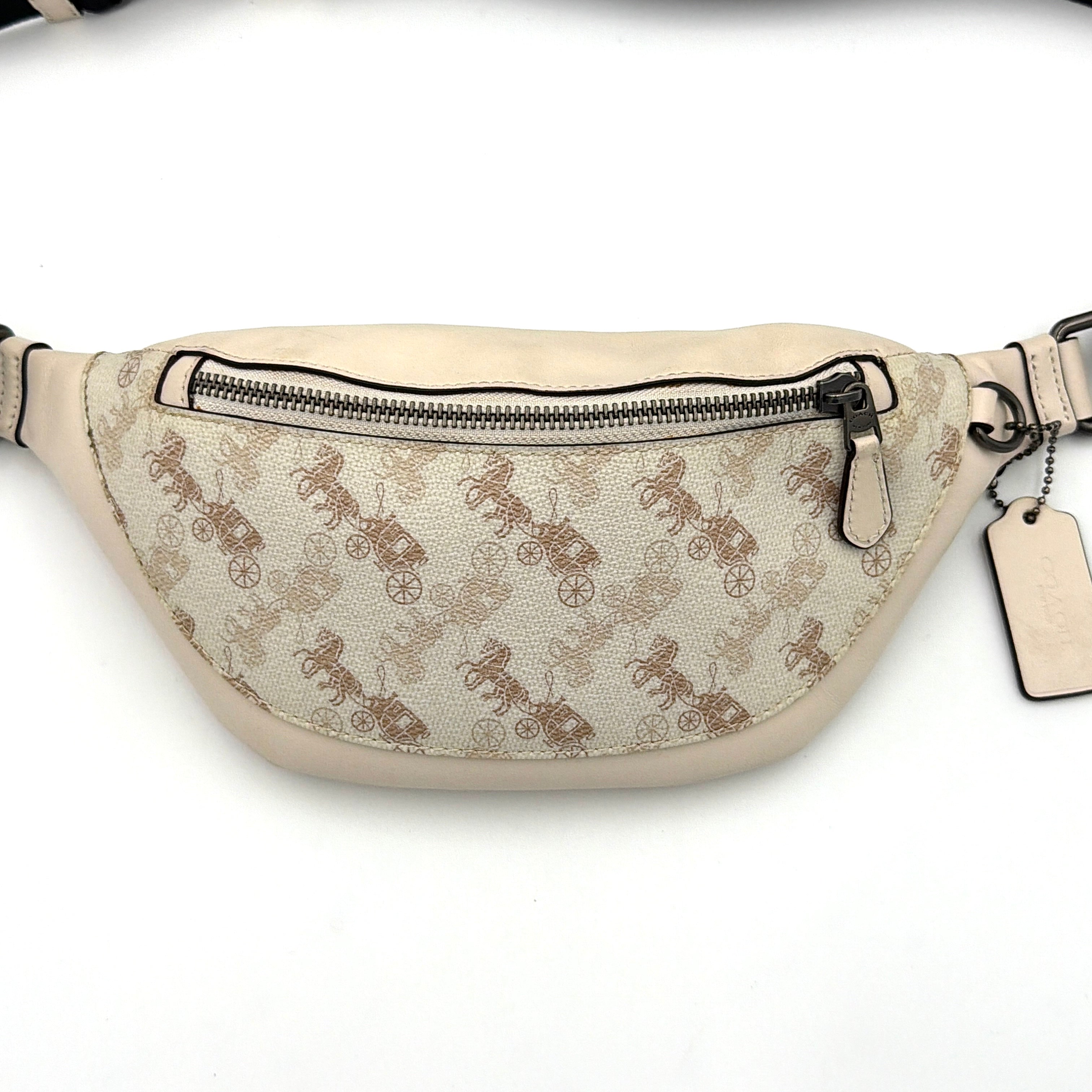 Coach Mini Warren belt bag in cream canvas with tan horse and carriage motif, leather trim, and black adjustable strap.