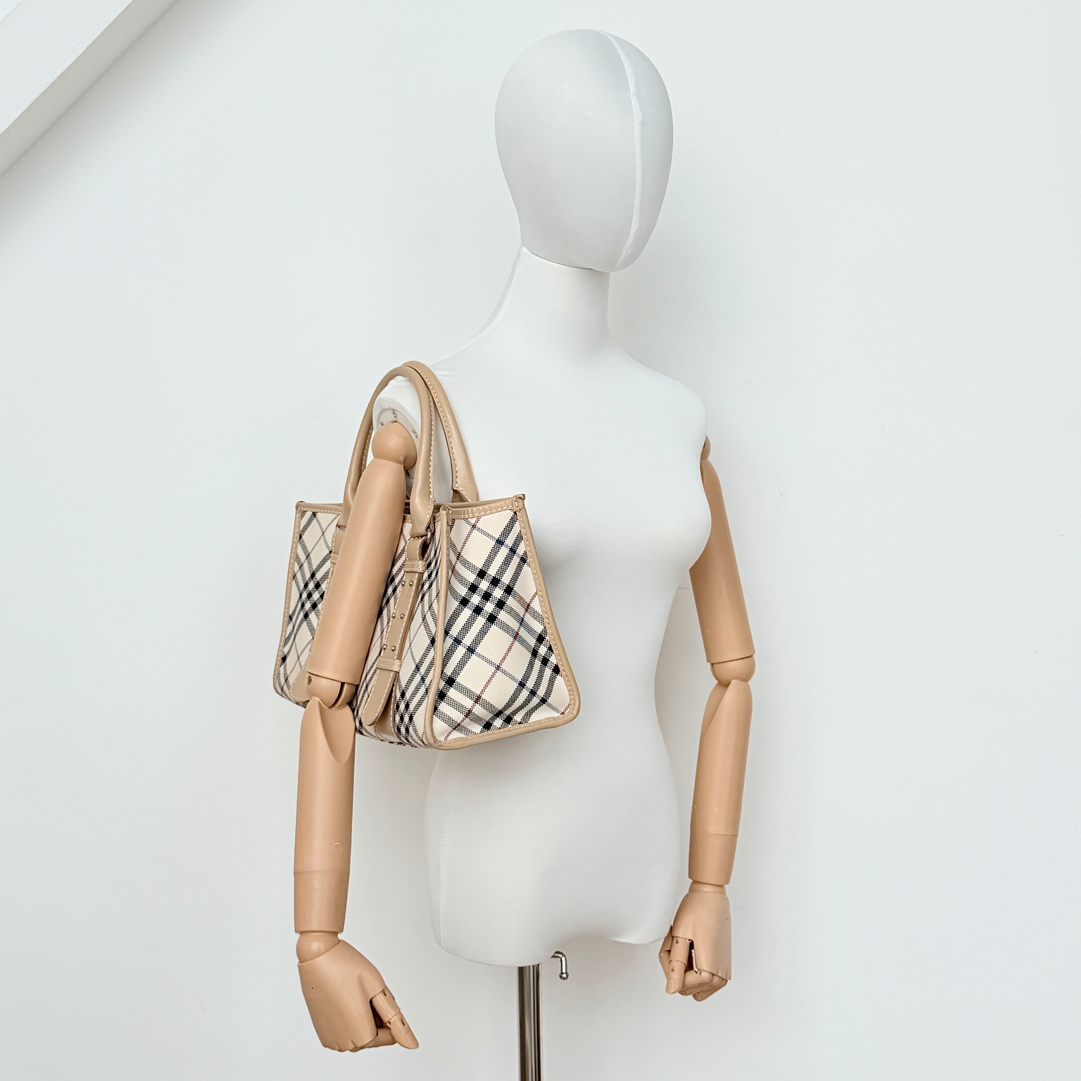 Burberry Blue Label Nova Check handbag in beige with leather trim and double top handles, displayed against a white background.