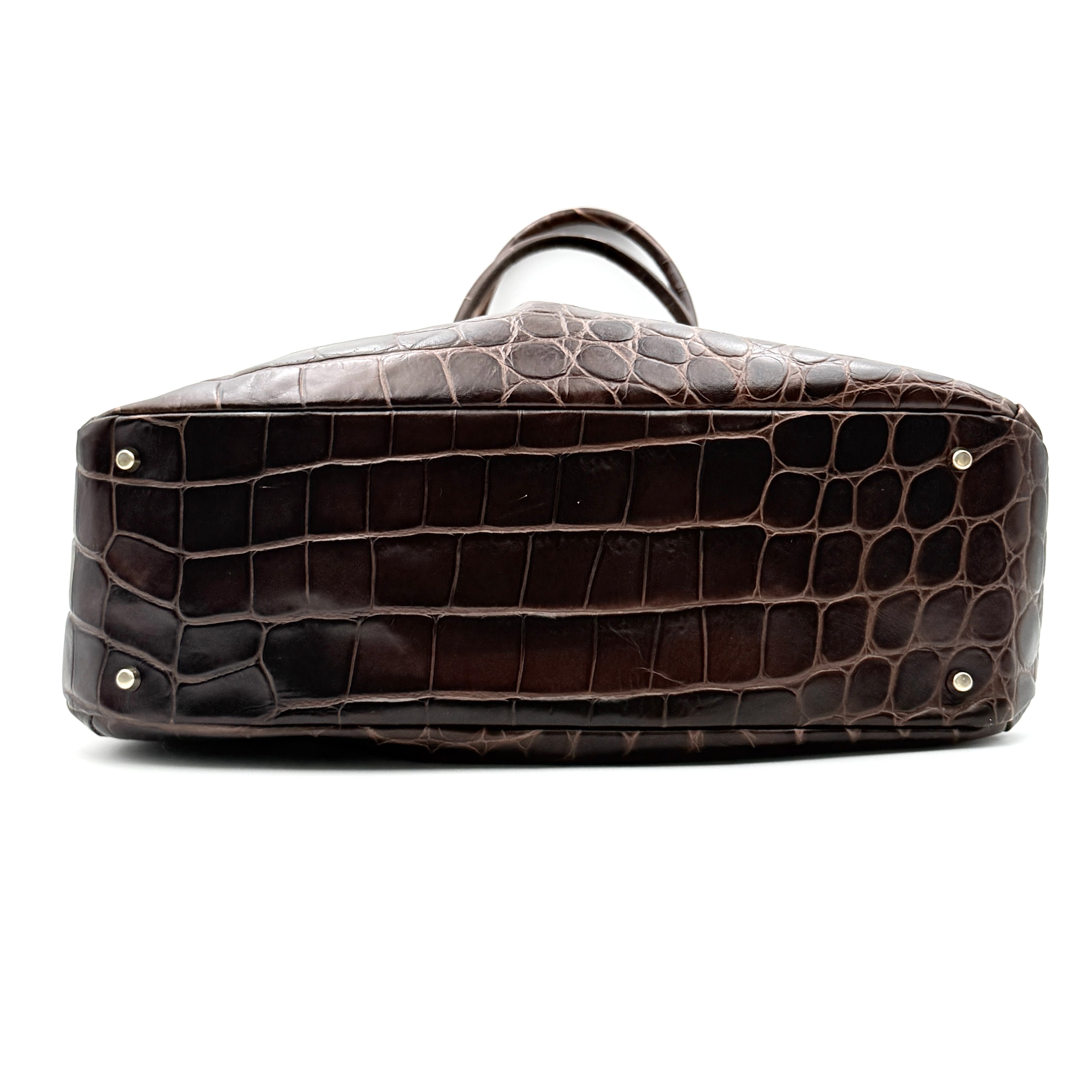 Furla dark brown croc-embossed leather tote bag with gold logo charm, structured silhouette, and double handles.