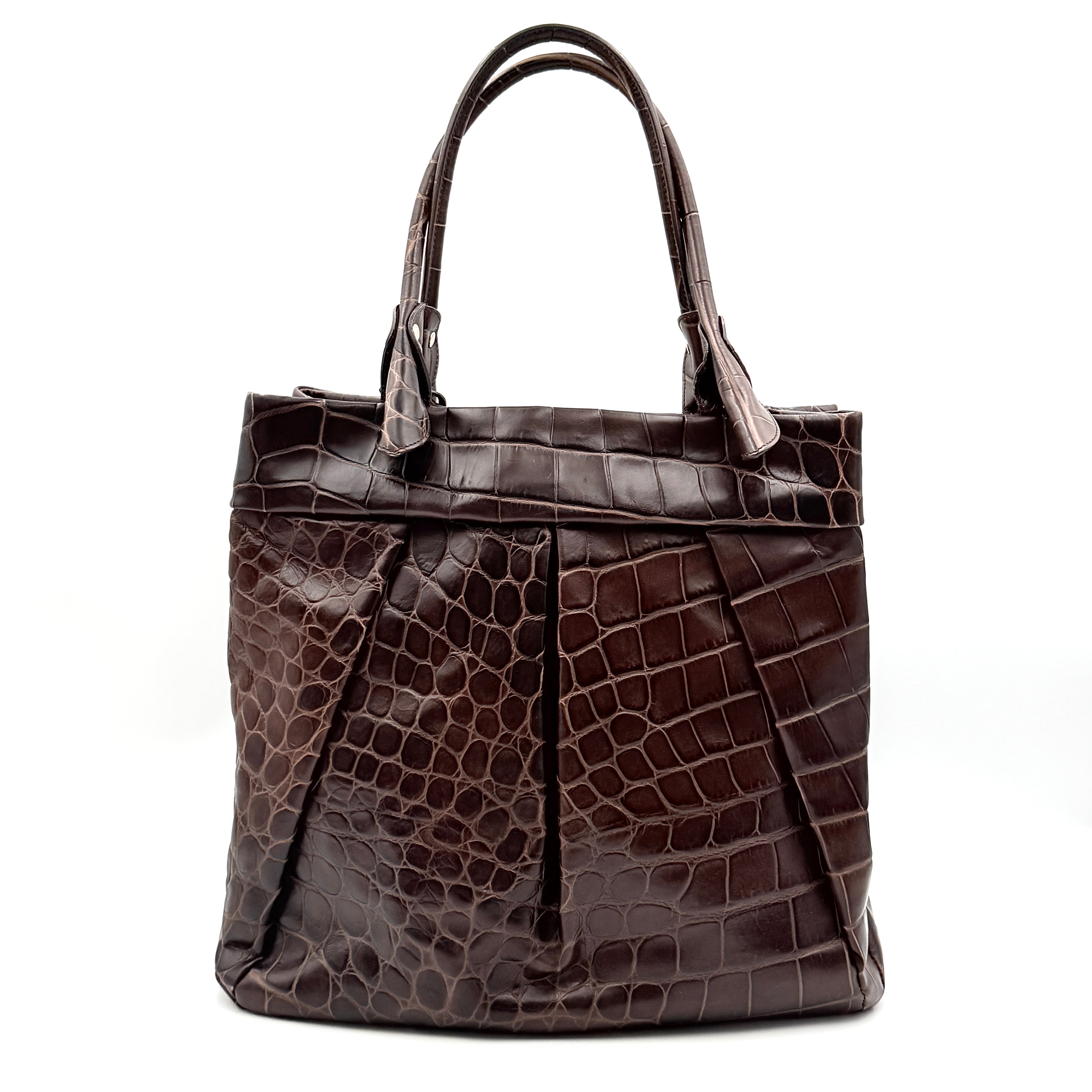 Furla dark brown croc-embossed leather tote bag with gold logo charm, structured silhouette, and double handles.
