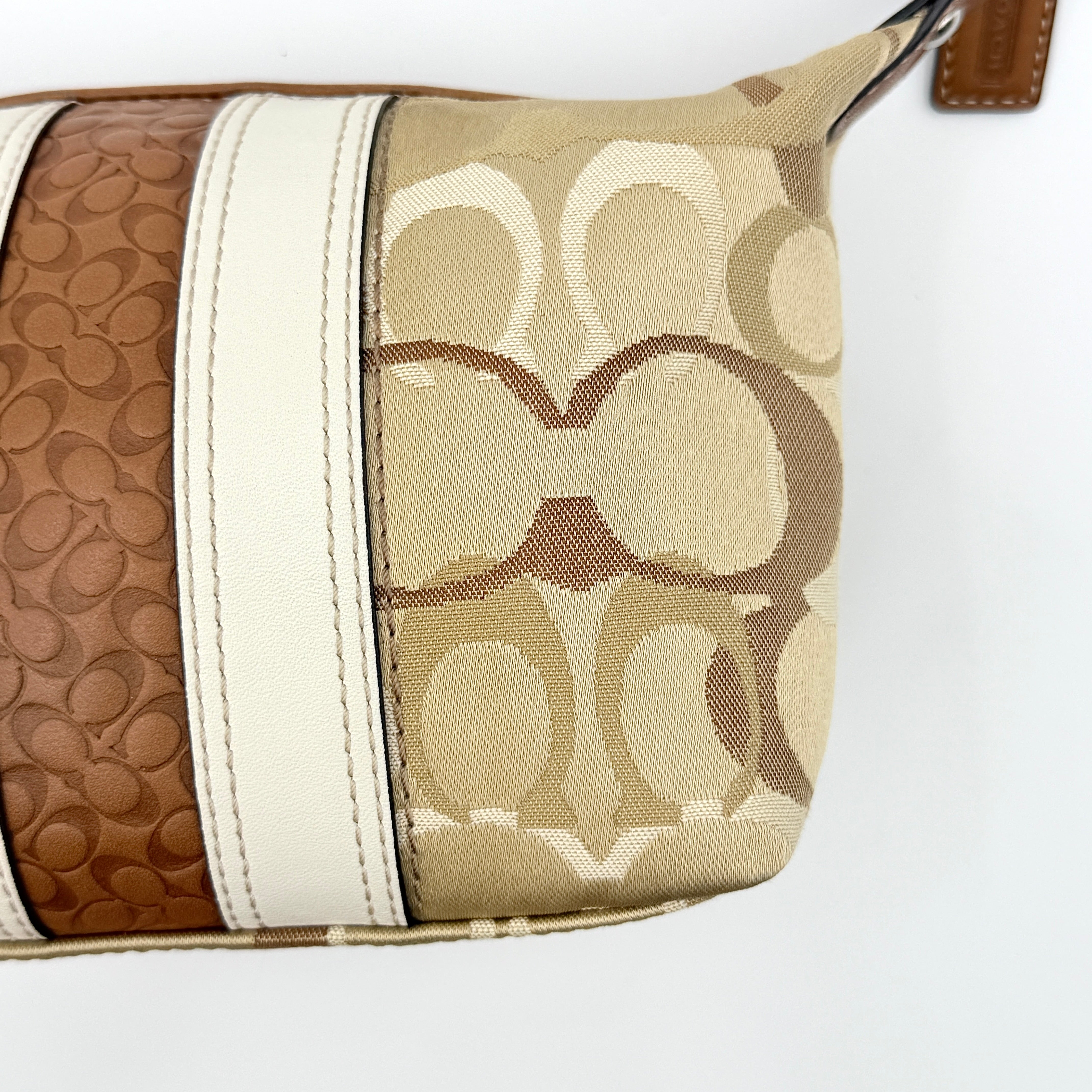 Coach Signature Stripe Mini Hobo Shoulder Bag in brown canvas with white and caramel stripes, featuring a brown leather strap and playful cherry charms.