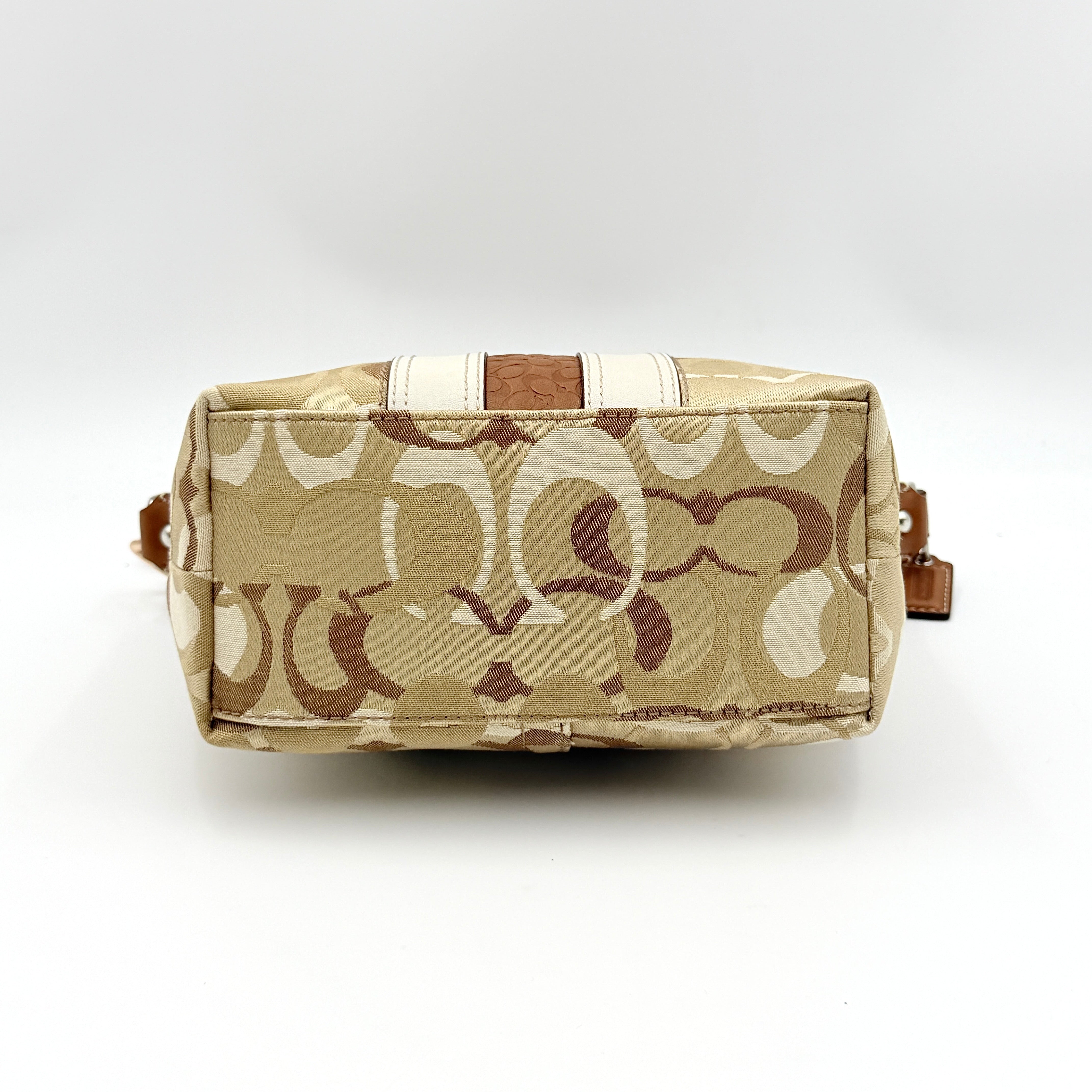 Coach Signature Stripe Mini Hobo Shoulder Bag in brown canvas with white and caramel stripes, featuring a brown leather strap and playful cherry charms.
