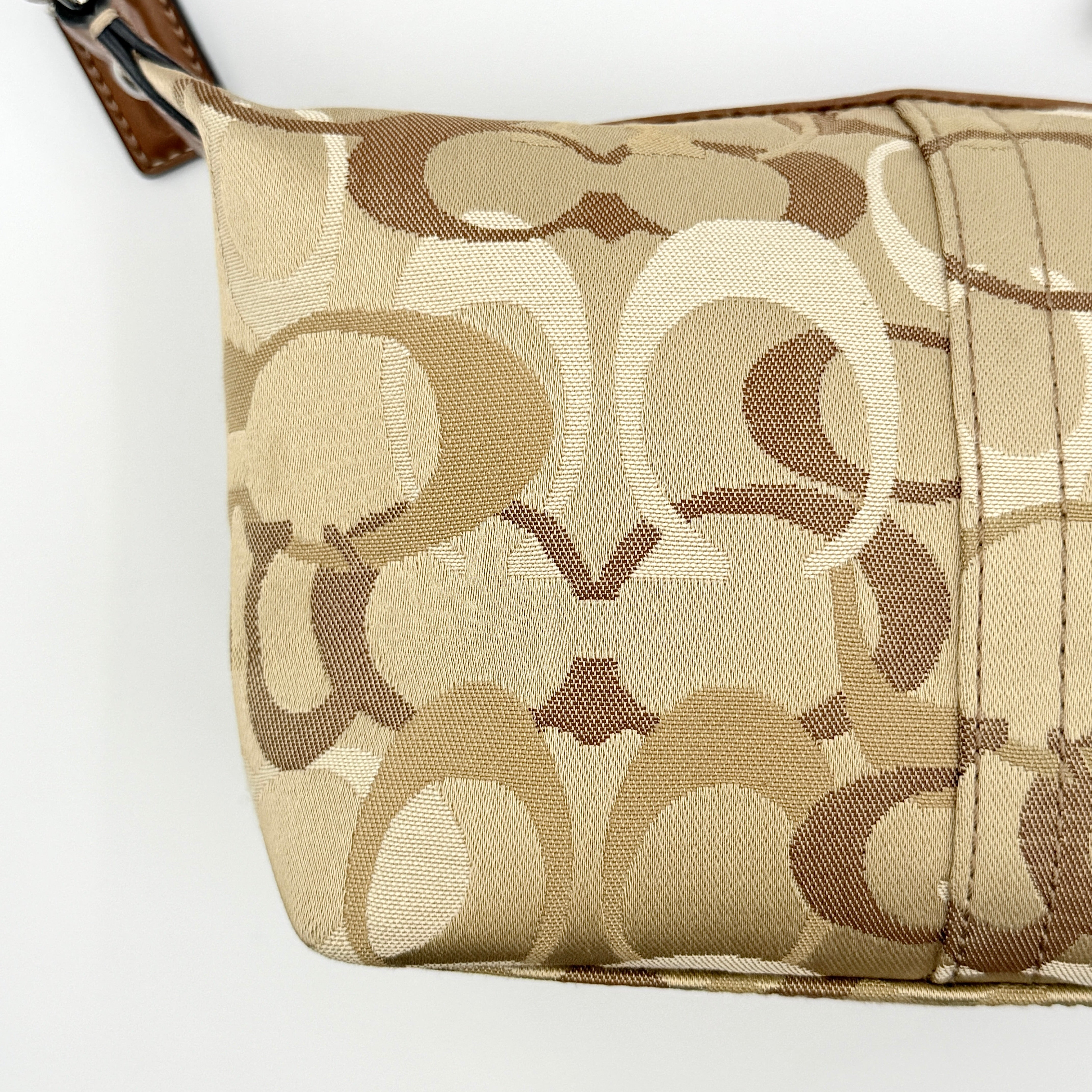Coach Signature Stripe Mini Hobo Shoulder Bag in brown canvas with white and caramel stripes, featuring a brown leather strap and playful cherry charms.