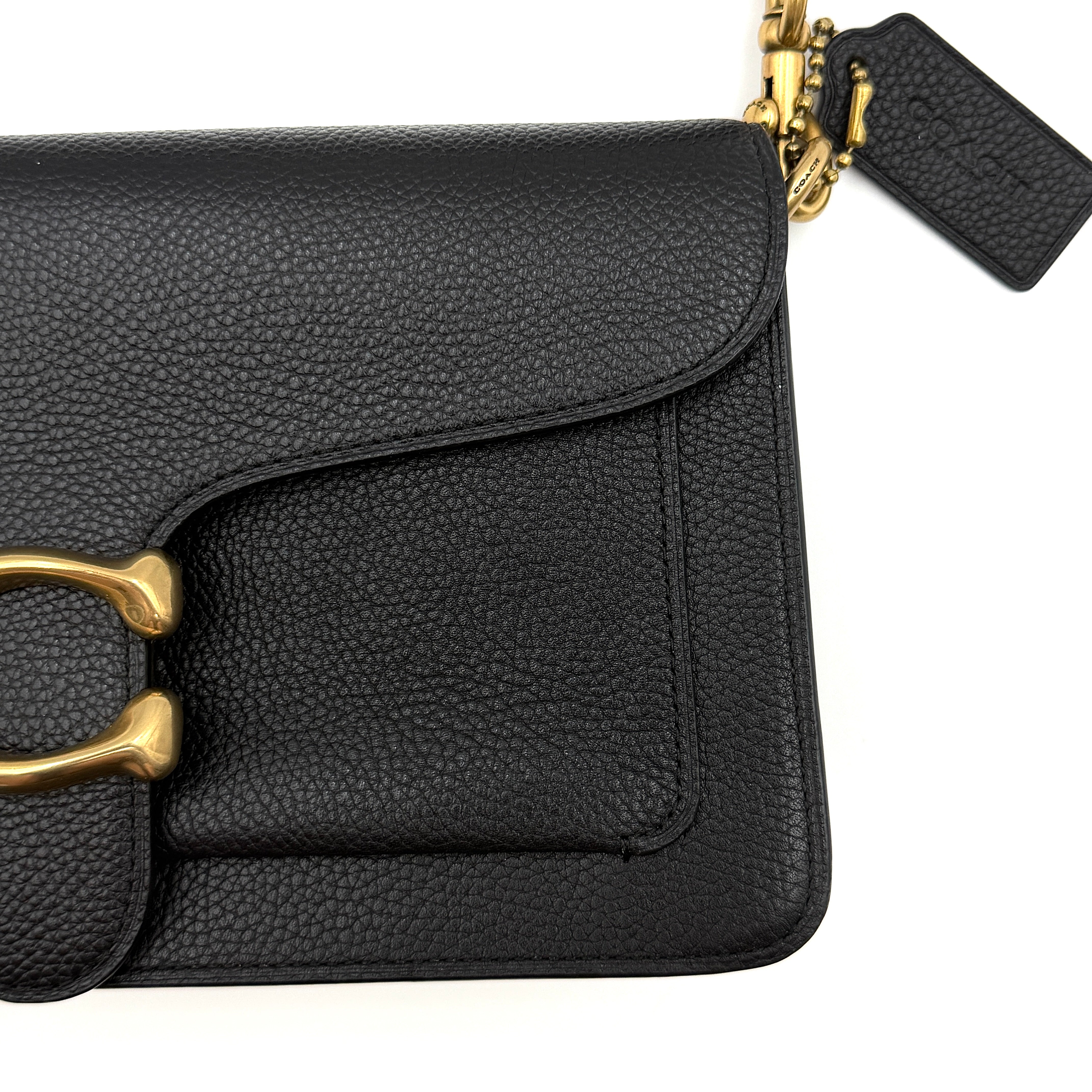 Coach Tabby 26 black shoulder bag with gold hardware and detachable straps, shown with dust bag and care card.