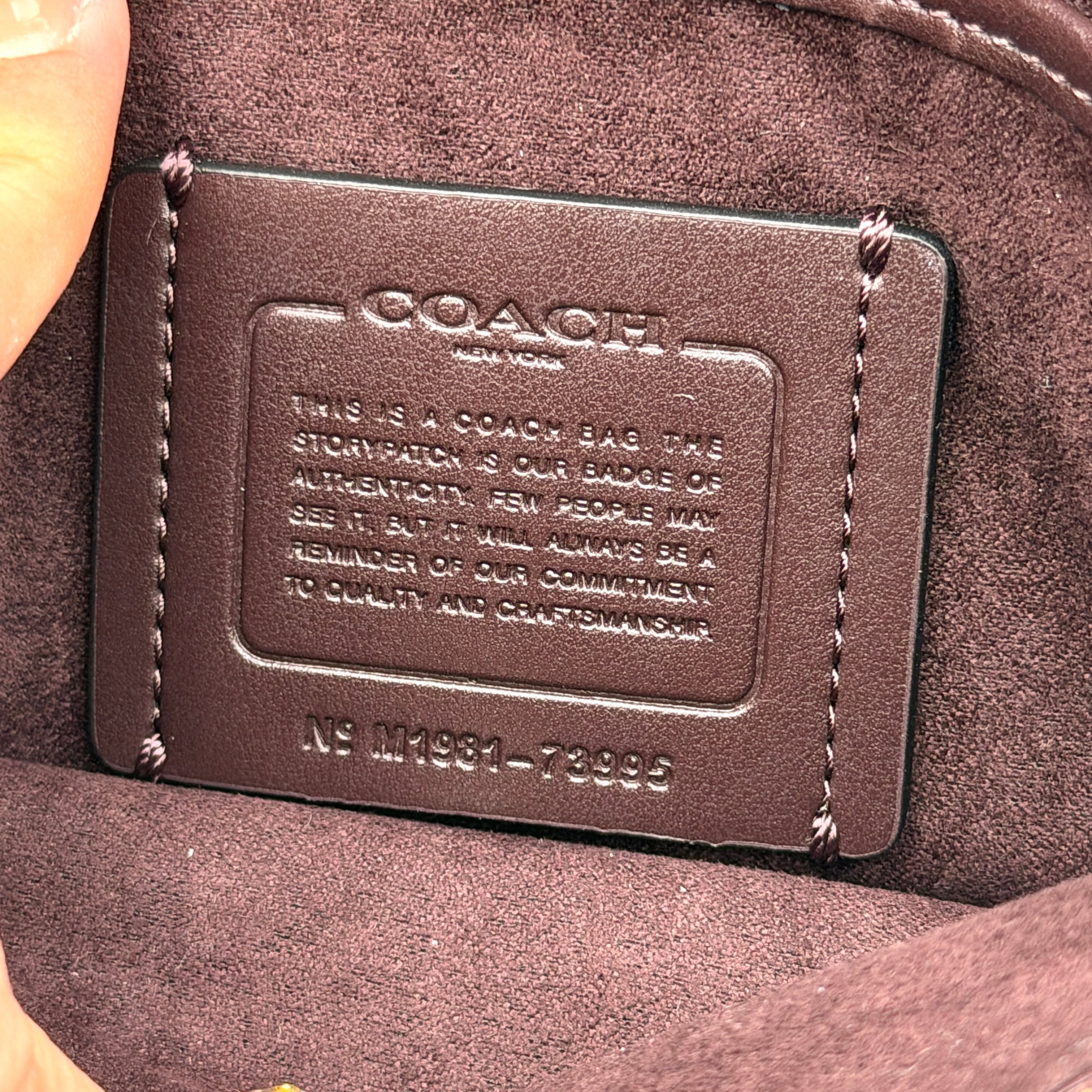 Coach Tabby 26 black shoulder bag with gold hardware and detachable straps, shown with dust bag and care card.