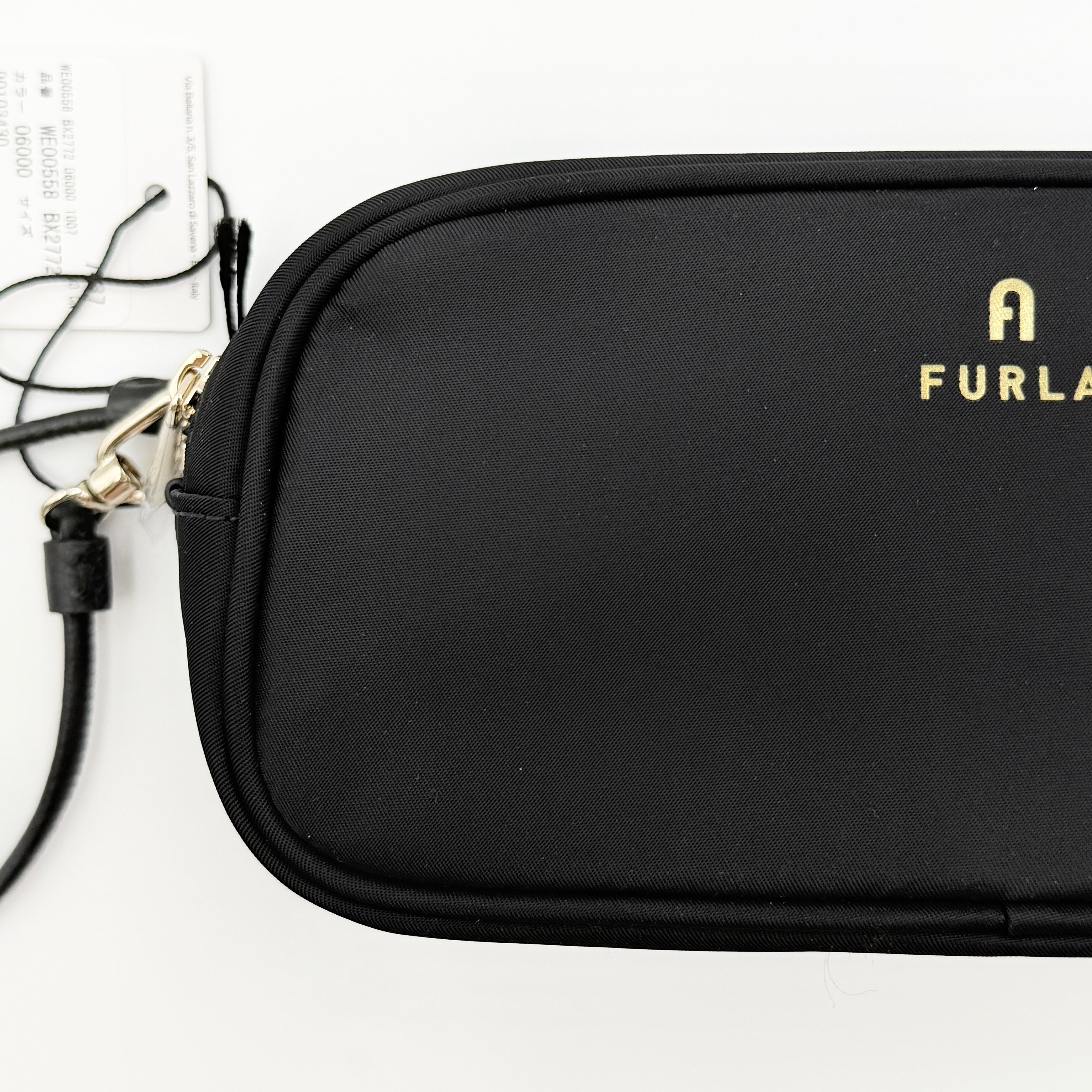 Furla Camelia Cosmetic Case in black nylon with gold logo and wristlet strap, shown with original tag.