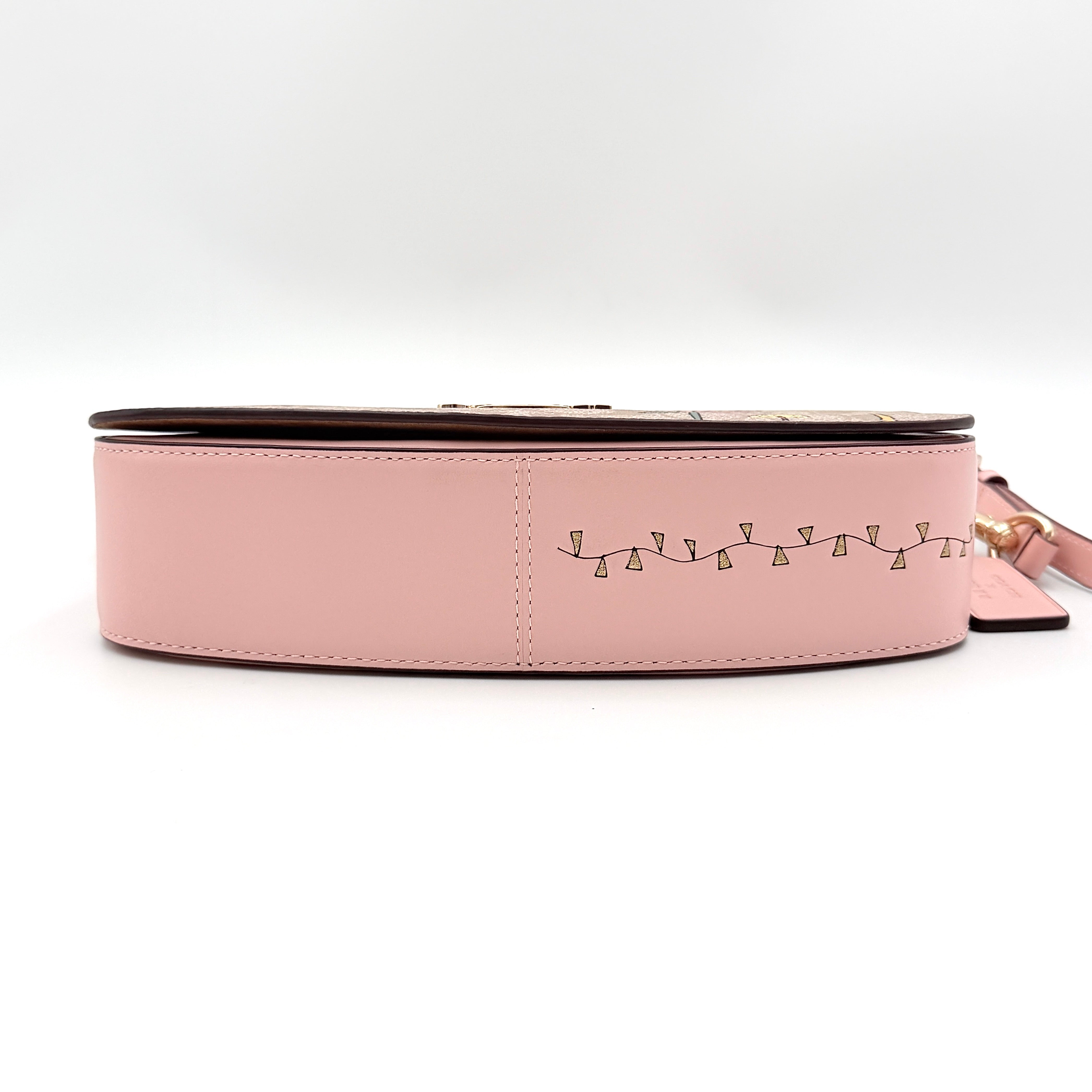 Coach X Observed By Us Andrea Shoulder Bag in beige monogram canvas with pink illustrations and pink leather strap.