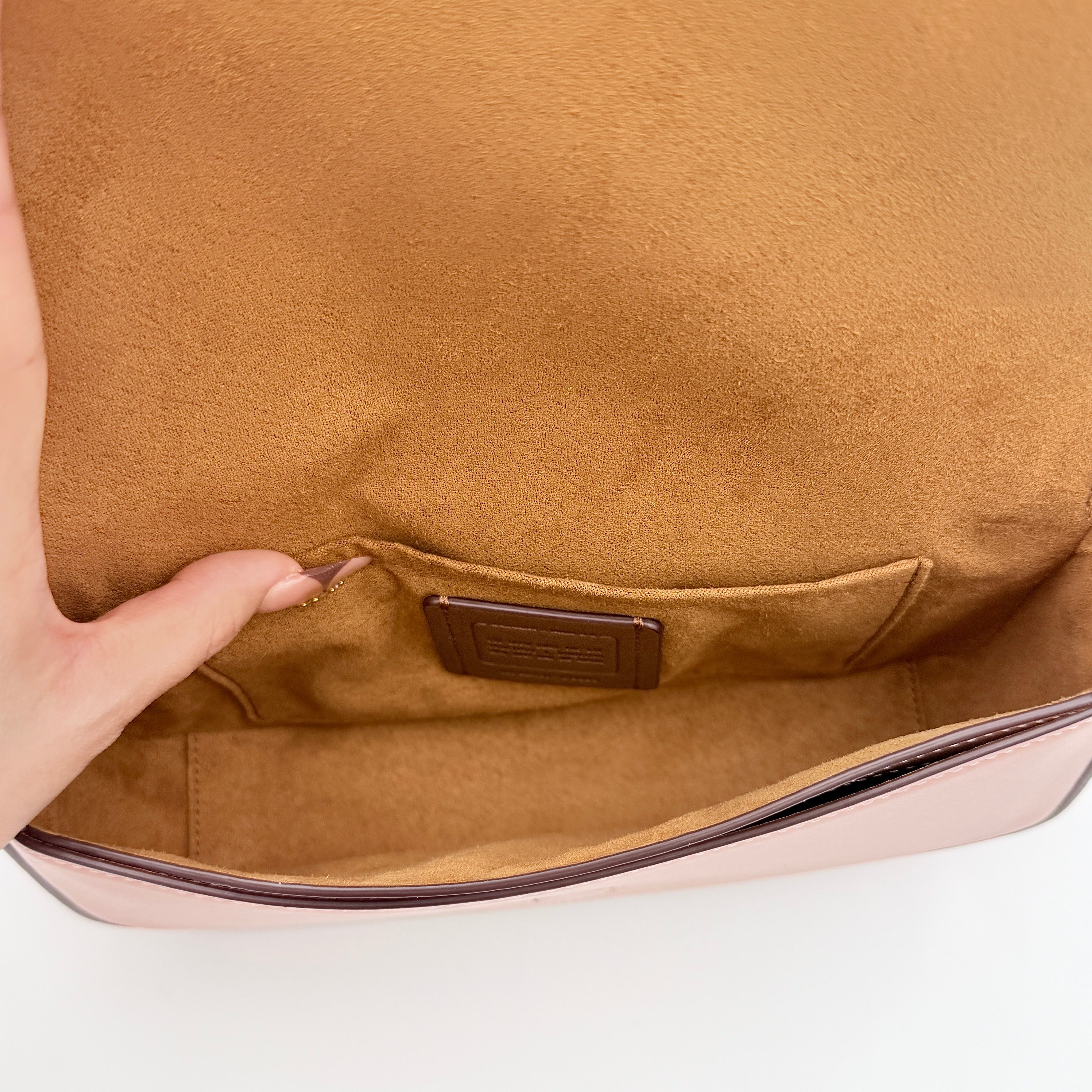 Coach X Observed By Us Andrea Shoulder Bag in beige monogram canvas with pink illustrations and pink leather strap.