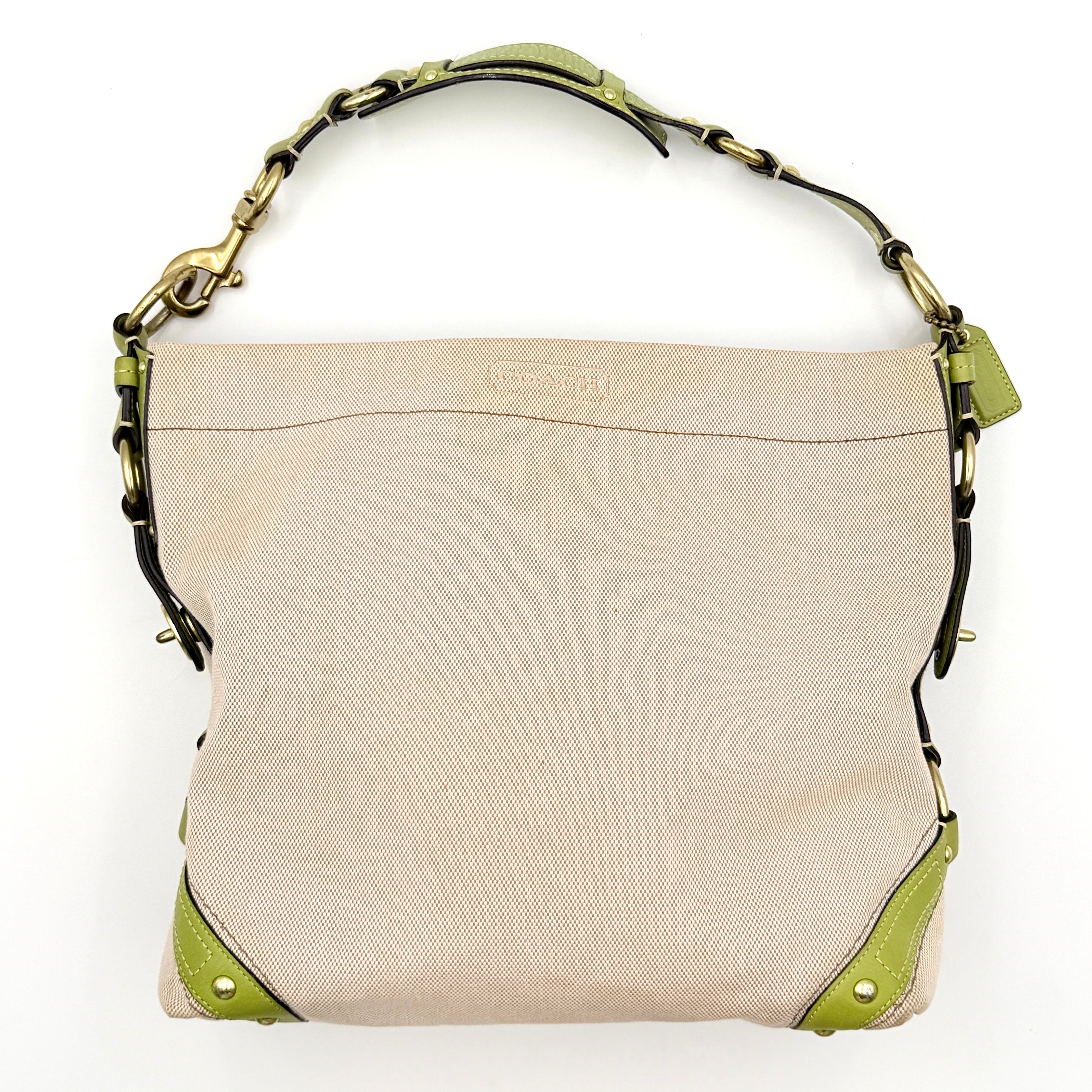 Coach Carly Hobo Shoulder Bag in beige canvas with green leather trim and gold hardware, shown on a white background.