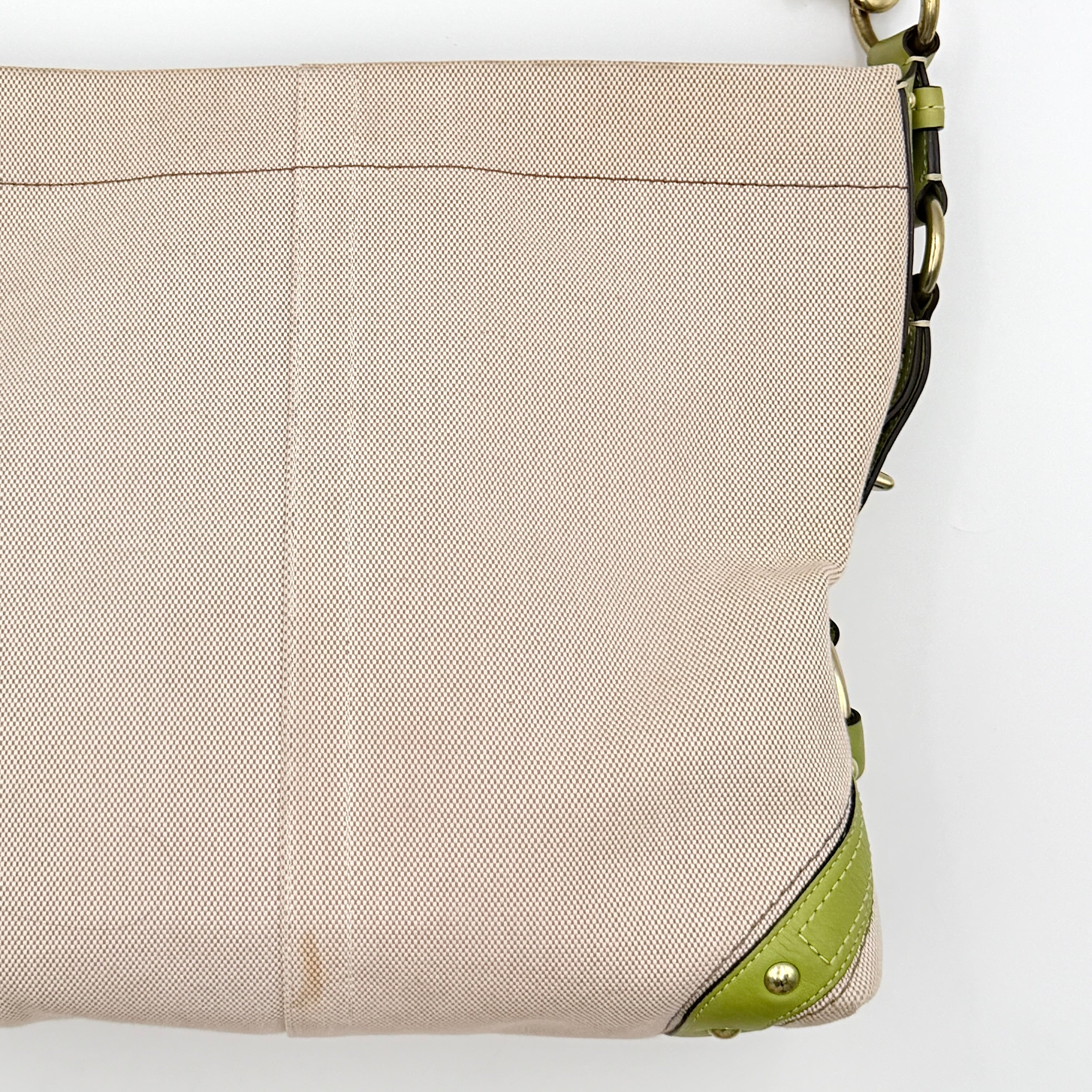 Coach Carly Hobo Shoulder Bag in beige canvas with green leather trim and gold hardware, shown on a white background.