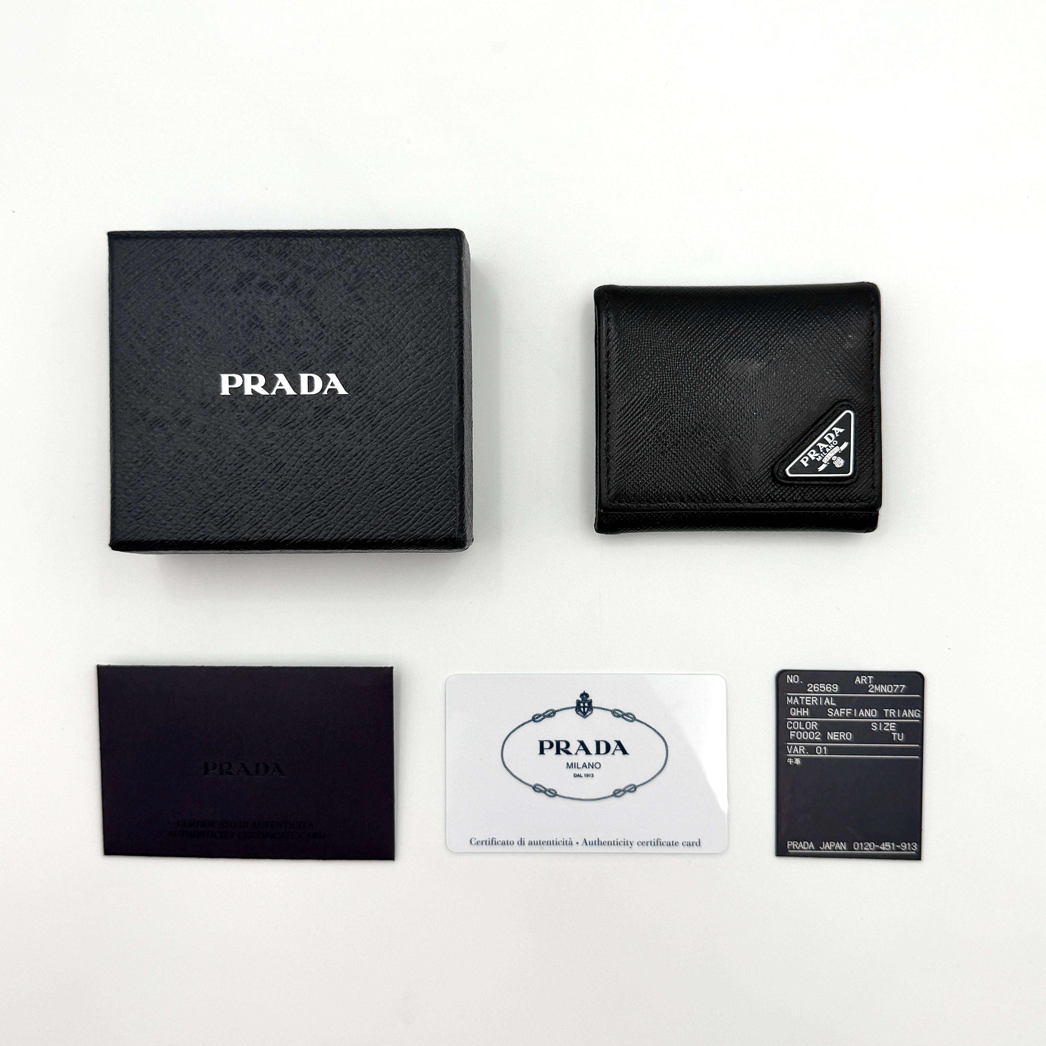 Prada Saffiano Triangle Logo Coin Case in black with silver enamel logo plaque at the corner.