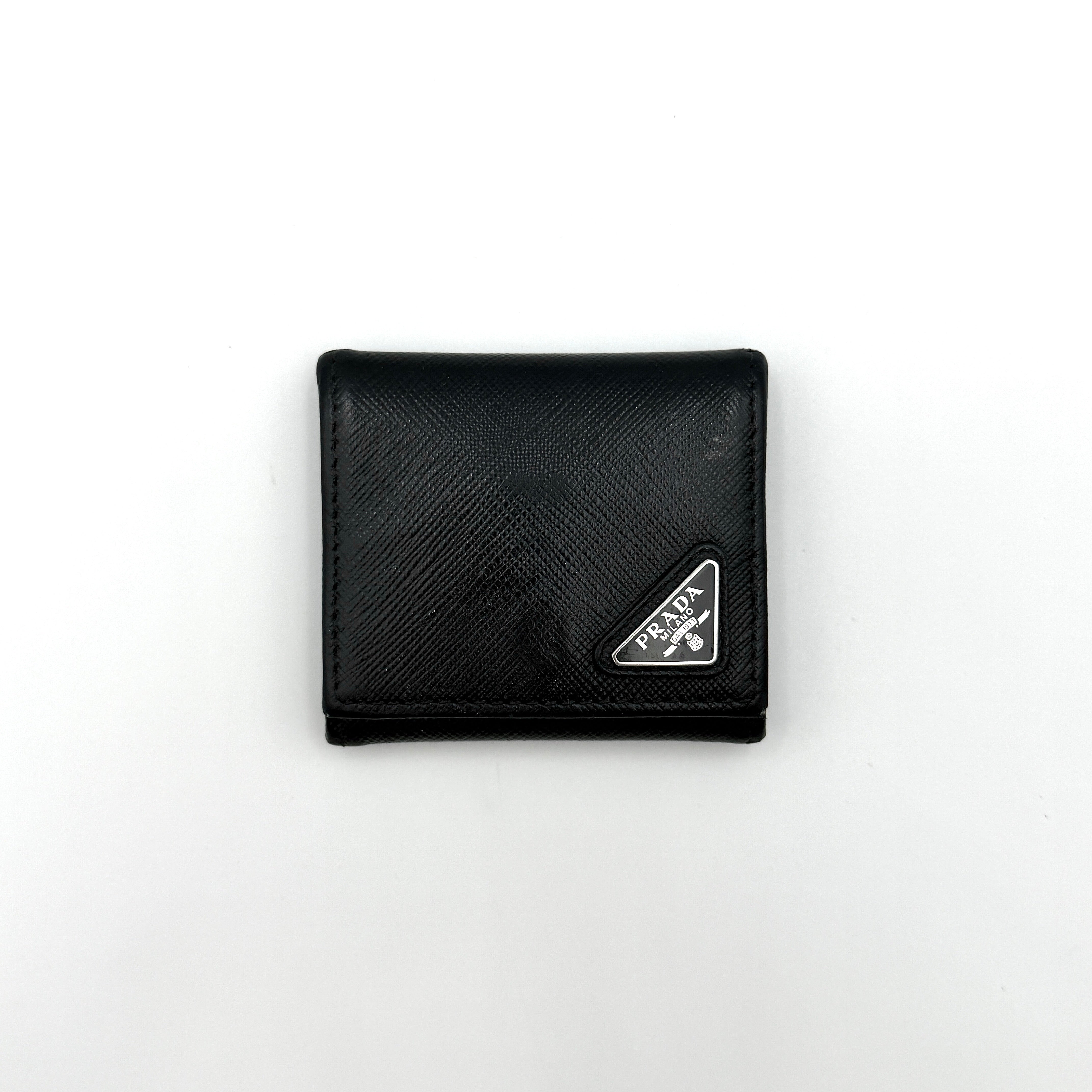Prada Saffiano Triangle Logo Coin Case in black with silver enamel logo plaque at the corner.