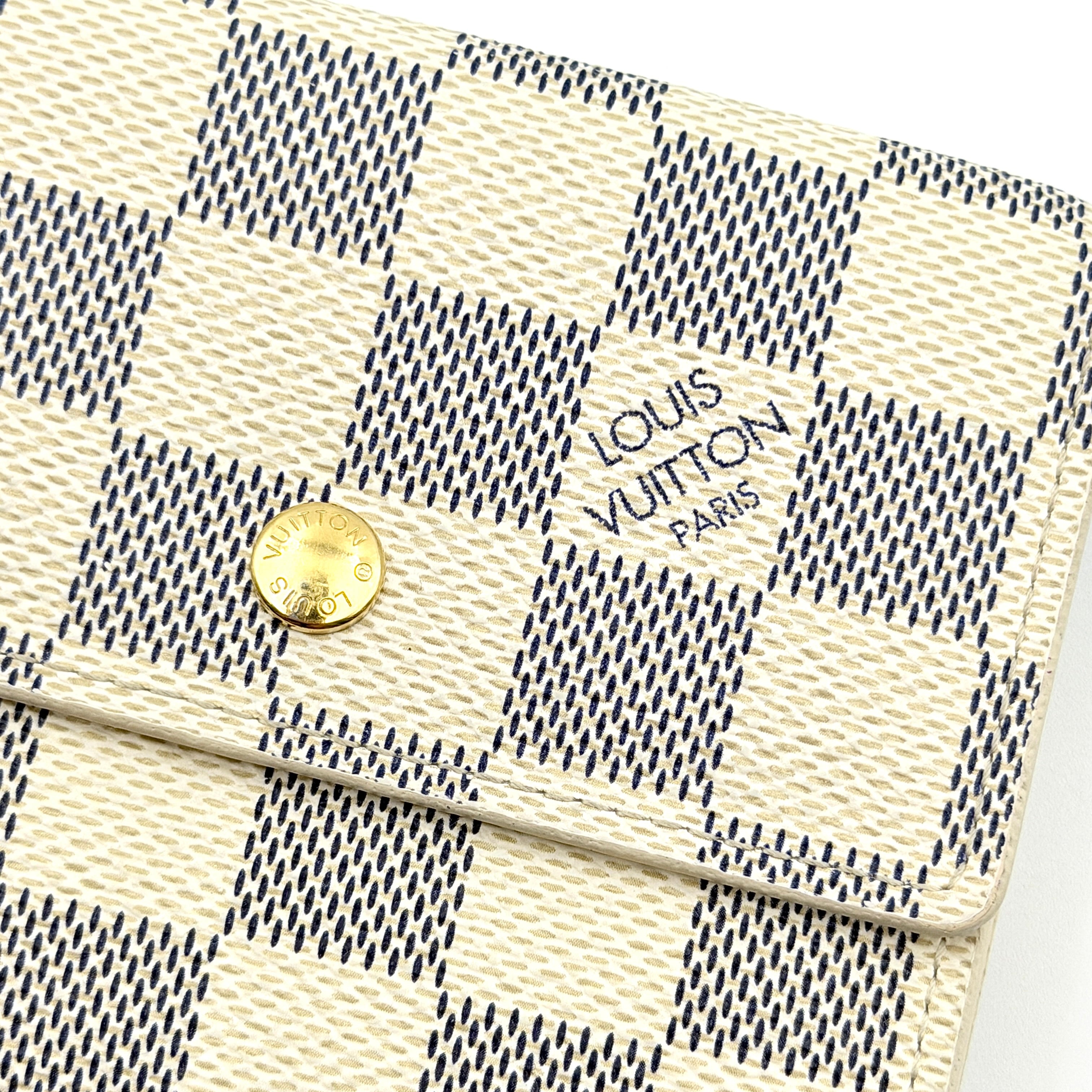 Louis Vuitton Damier Azur Elise Wallet in checked canvas with gold button snap, photographed on a clean white background.