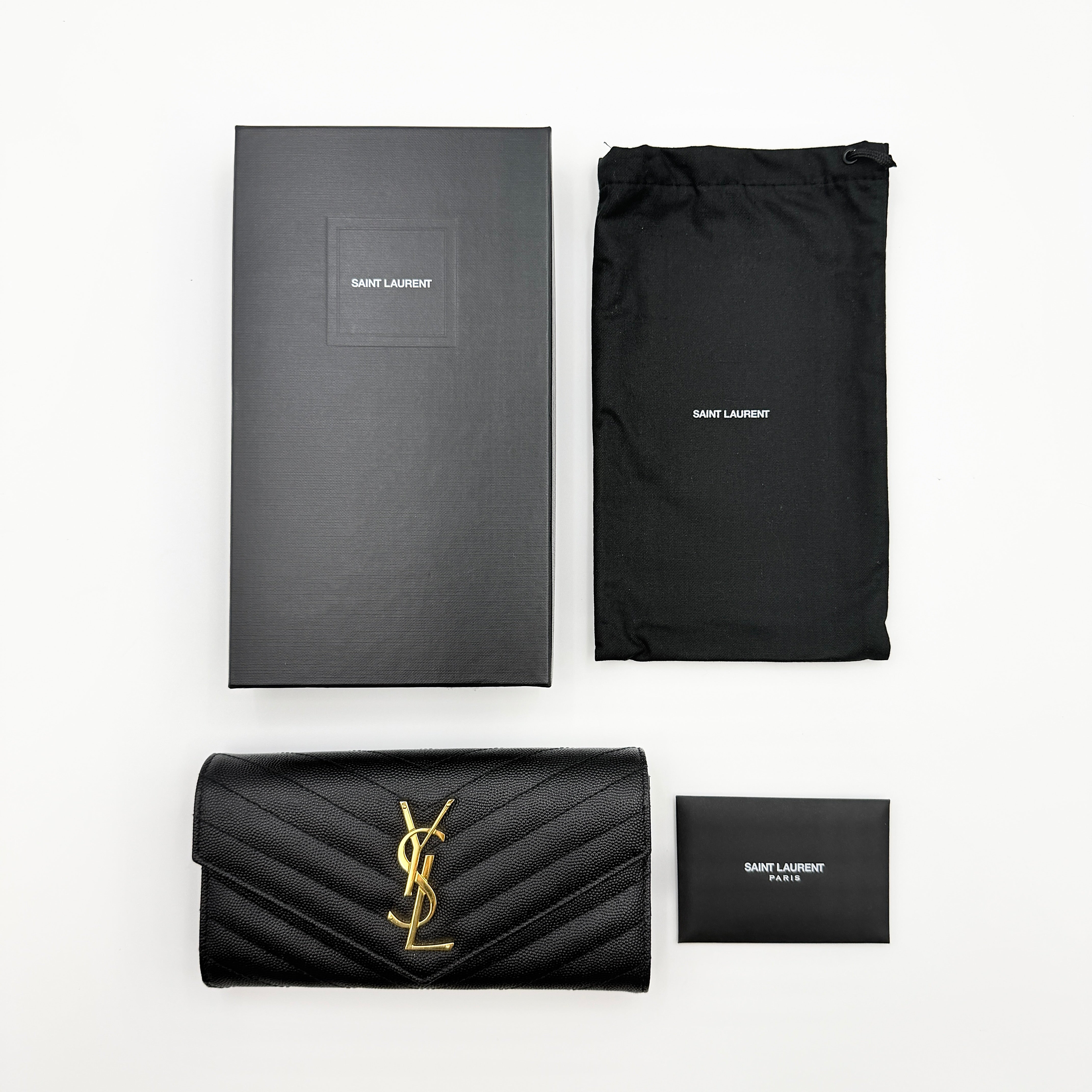 Saint Laurent Cassandre Large Flap Wallet in black grained leather with gold YSL monogram and chevron quilting.