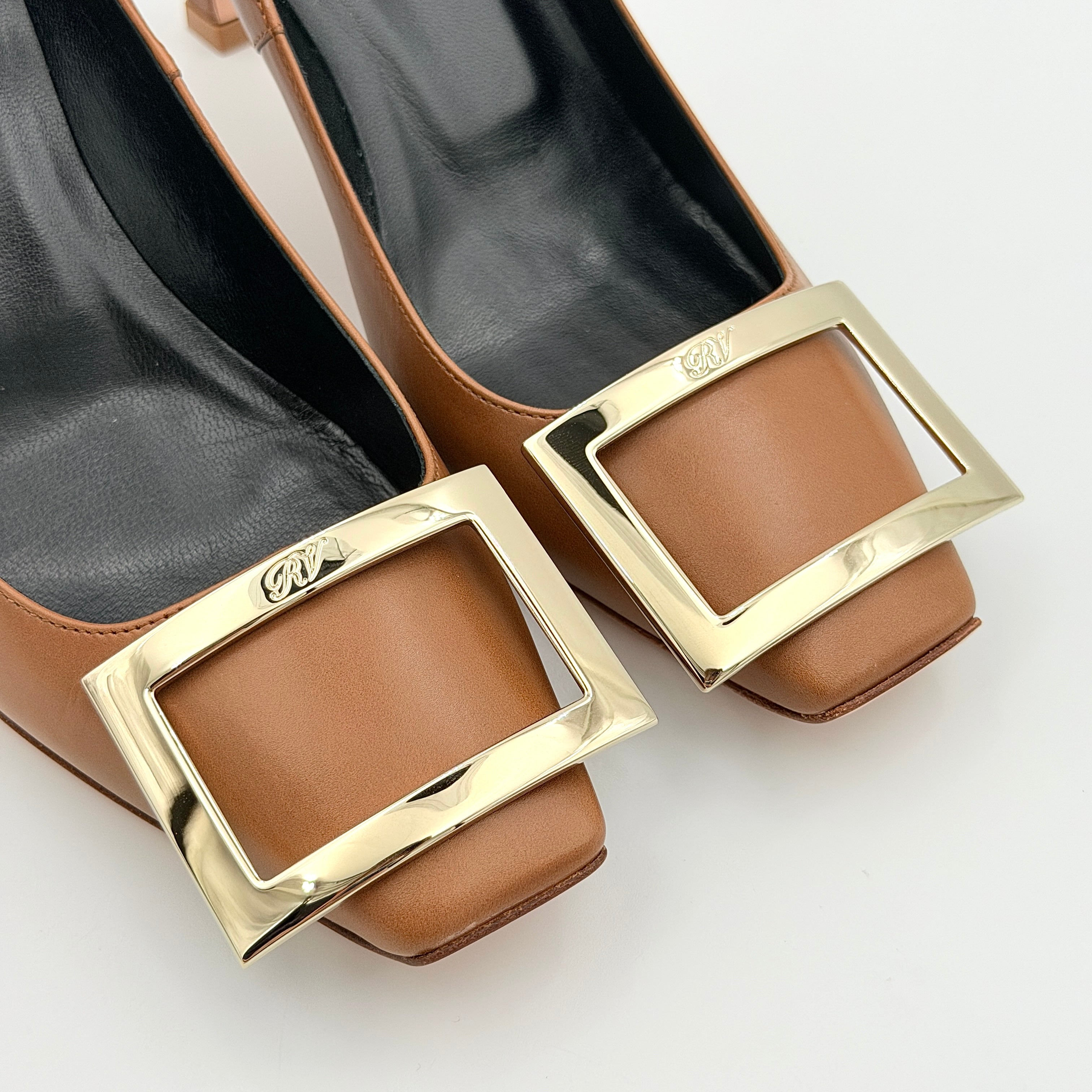 A pair of Roger Vivier Belle Vivier Trompette leather pumps in brown with gold-tone signature buckle and squared toe.