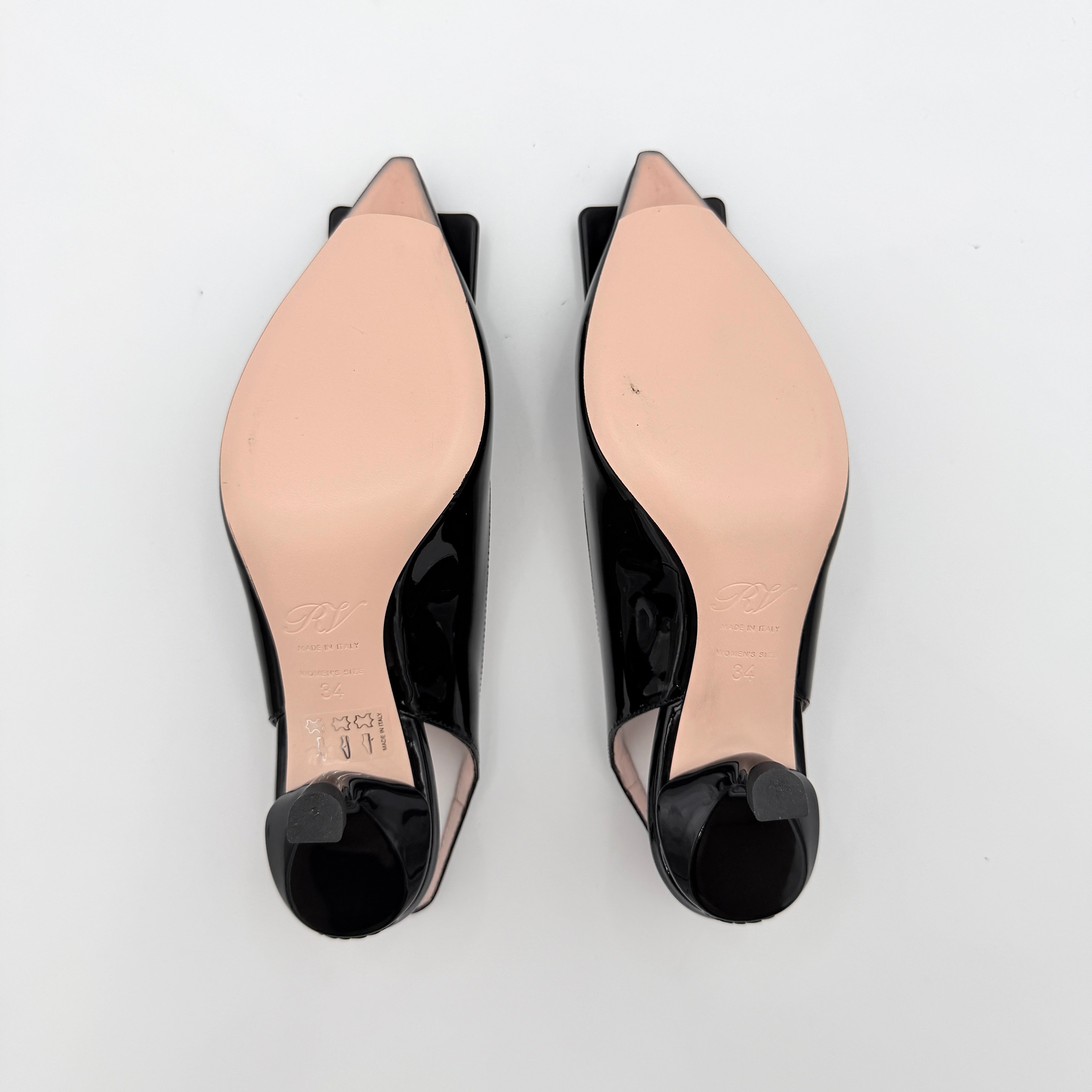 A pair of Roger Vivier Virgule black patent slingback pumps featuring a sculpted heel and oversized buckle at the toe.