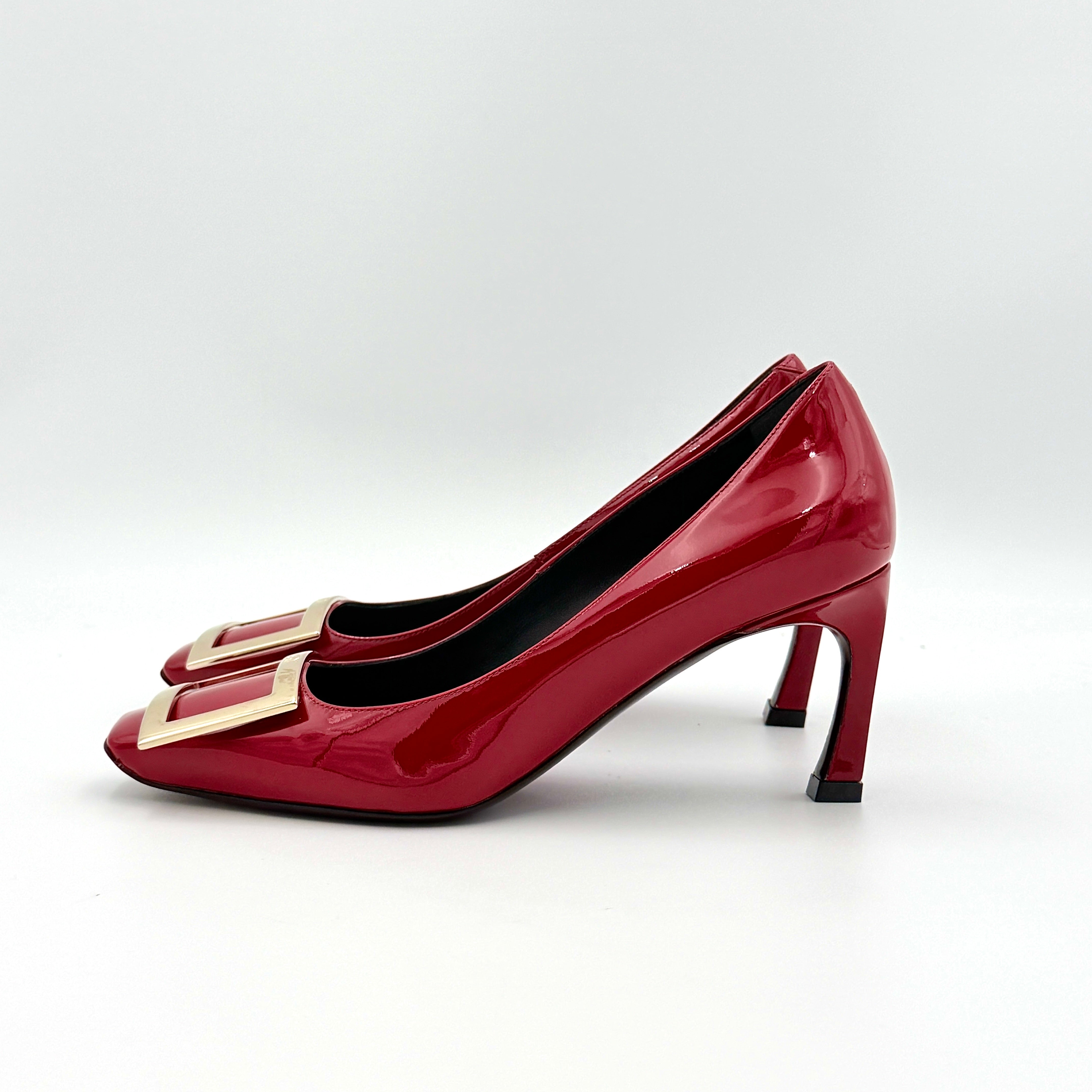 Pair of Roger Vivier Belle Vivier Trompette patent pumps in glossy red with gold-tone buckles, exuding a polished finish.