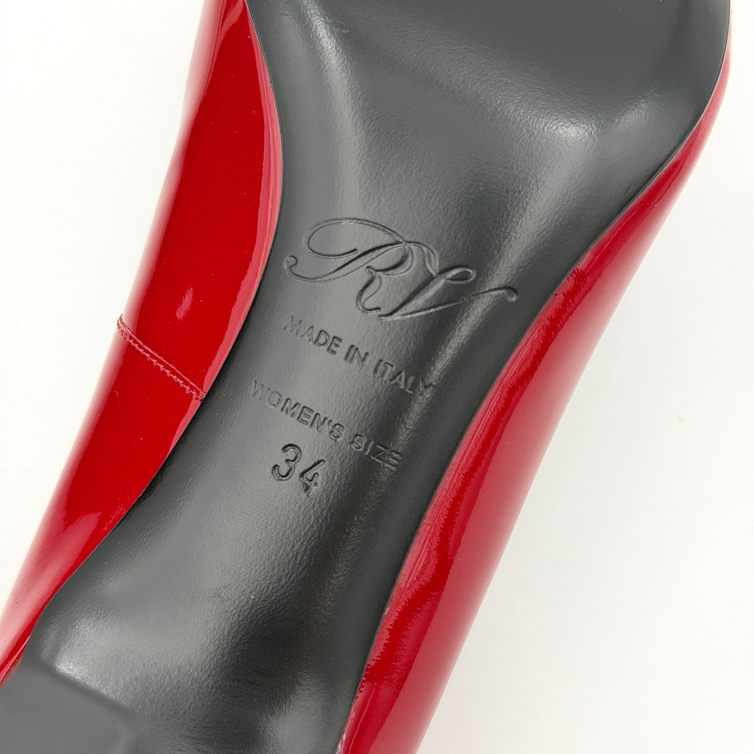 Pair of Roger Vivier Belle Vivier Trompette patent pumps in glossy red with gold-tone buckles, exuding a polished finish.