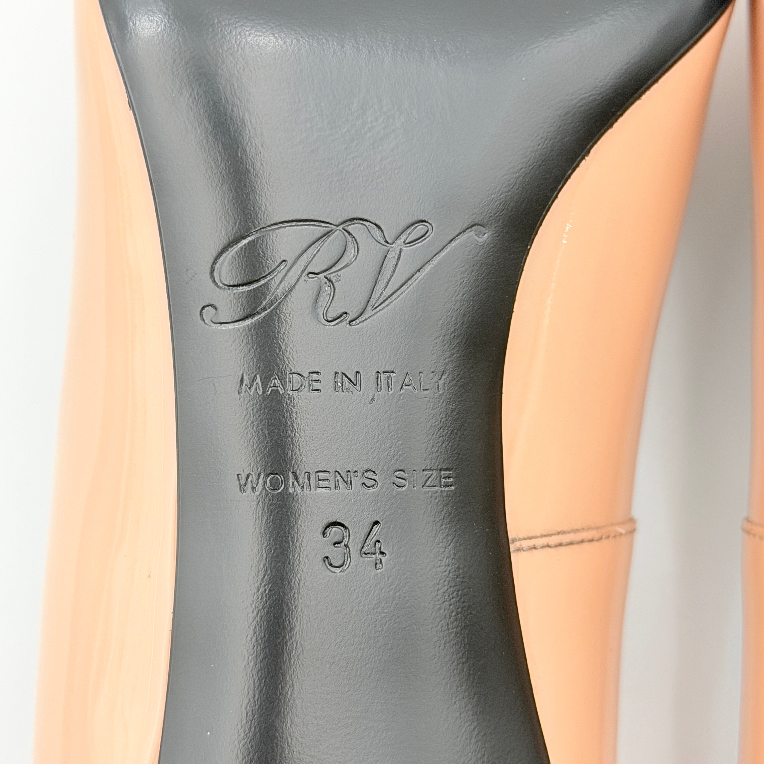 A pair of Roger Vivier Belle Vivier Trompette pumps in patent blush pink leather with signature gold buckles at the toe.
