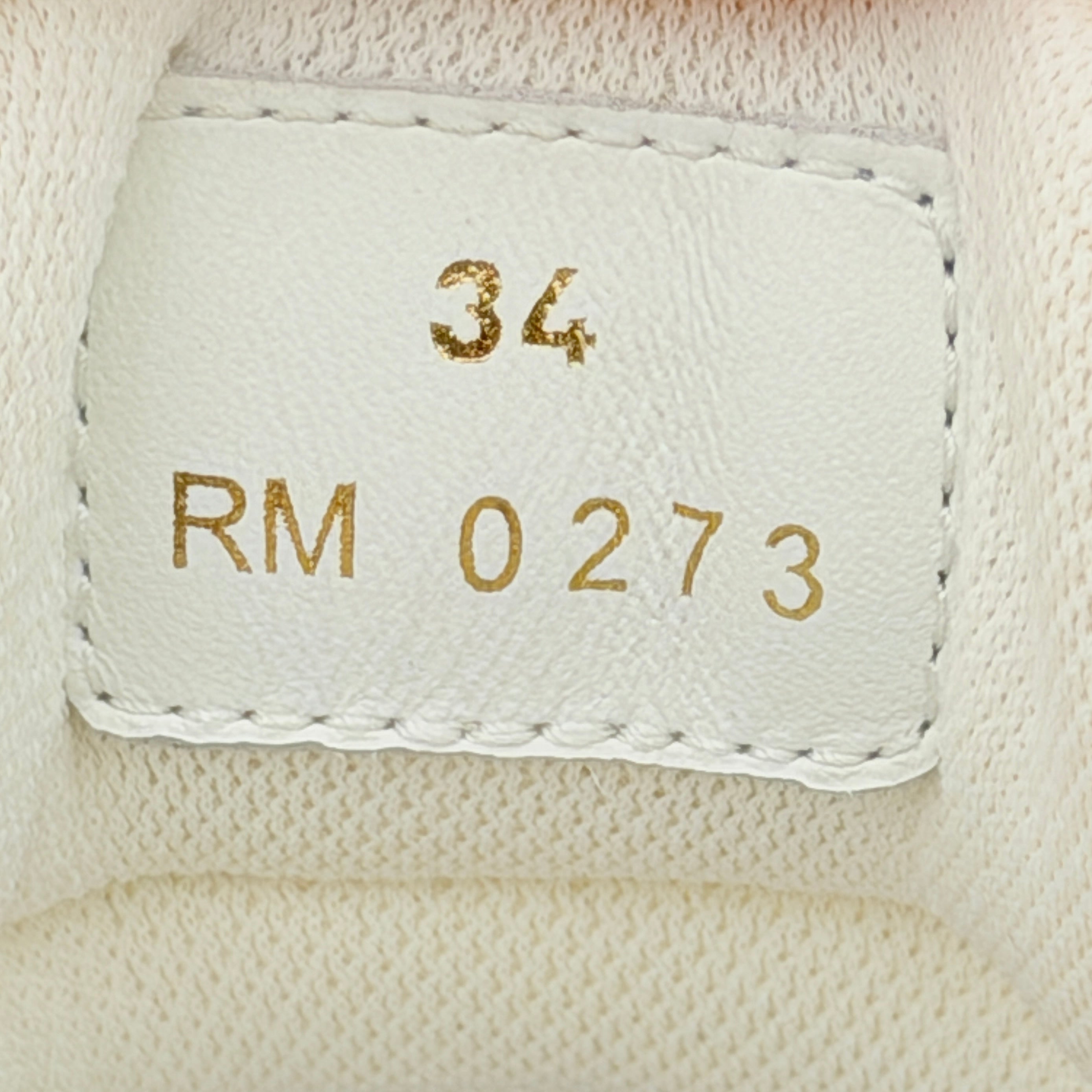 Celine white leather block platform sneakers with bold embossed sole and lace-up front, displayed at a slight angle.
