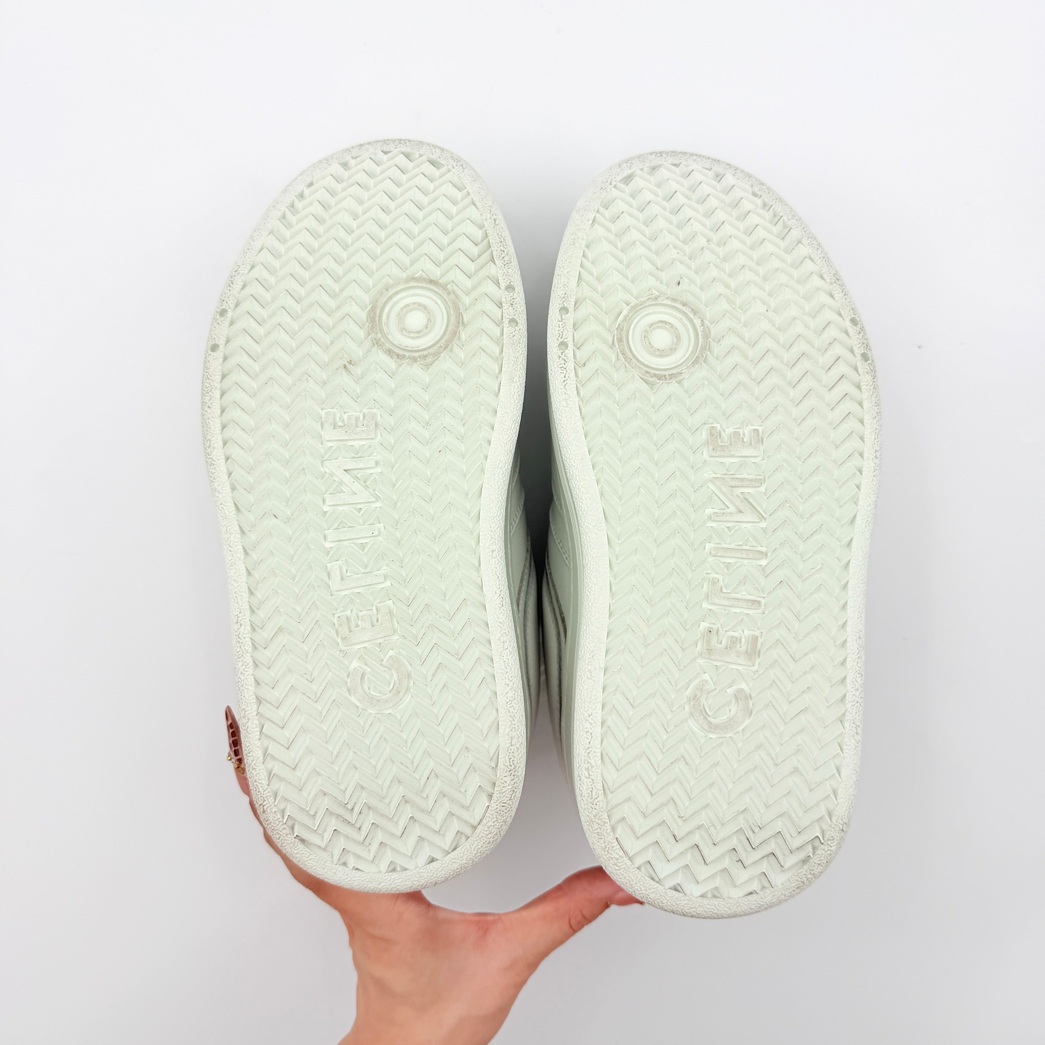 Celine white leather block platform sneakers with bold embossed sole and lace-up front, displayed at a slight angle.
