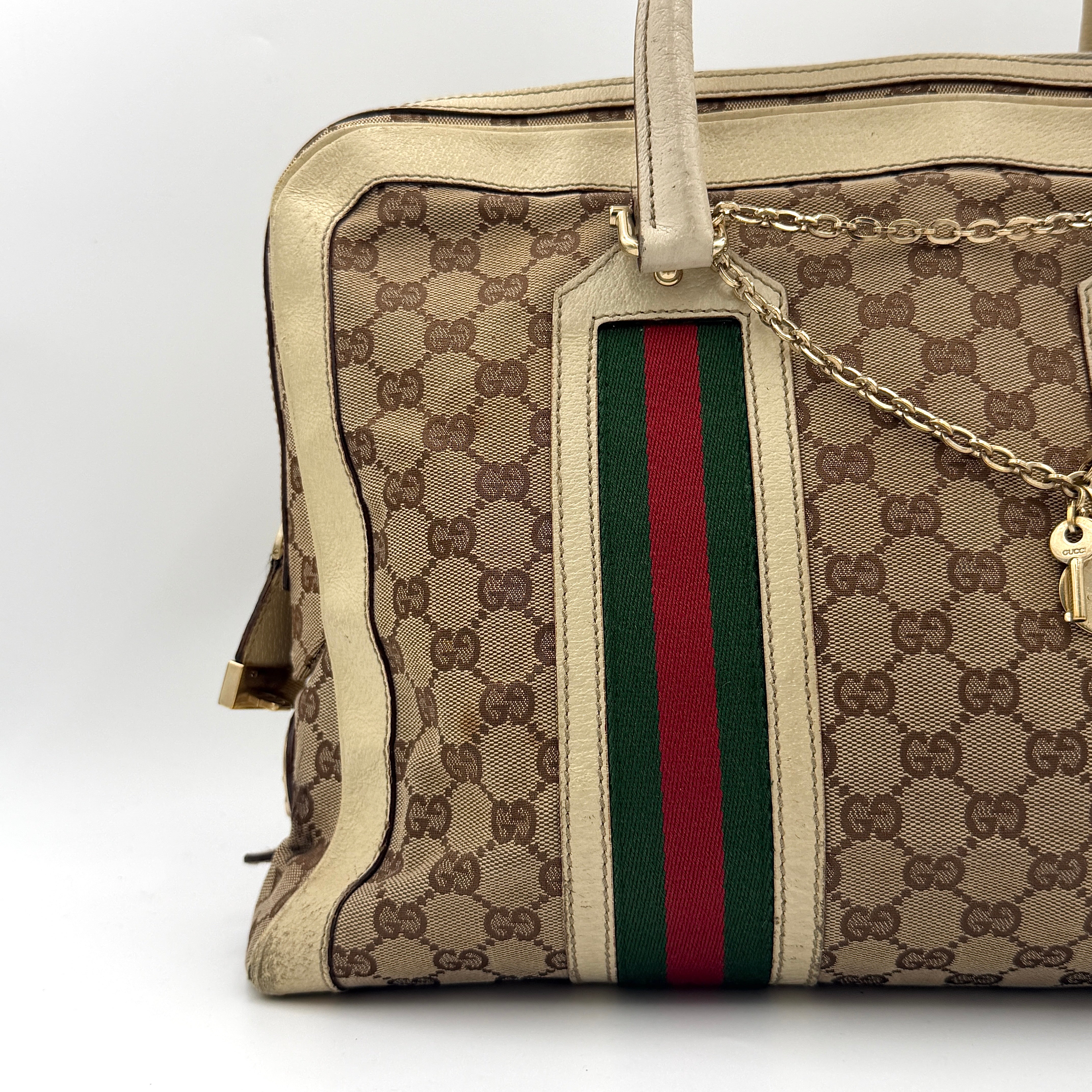 Gucci GG Monogram Stoffa Shoulder Bag in beige canvas with cream leather trim, iconic web stripes, and gold-tone chain detail.
