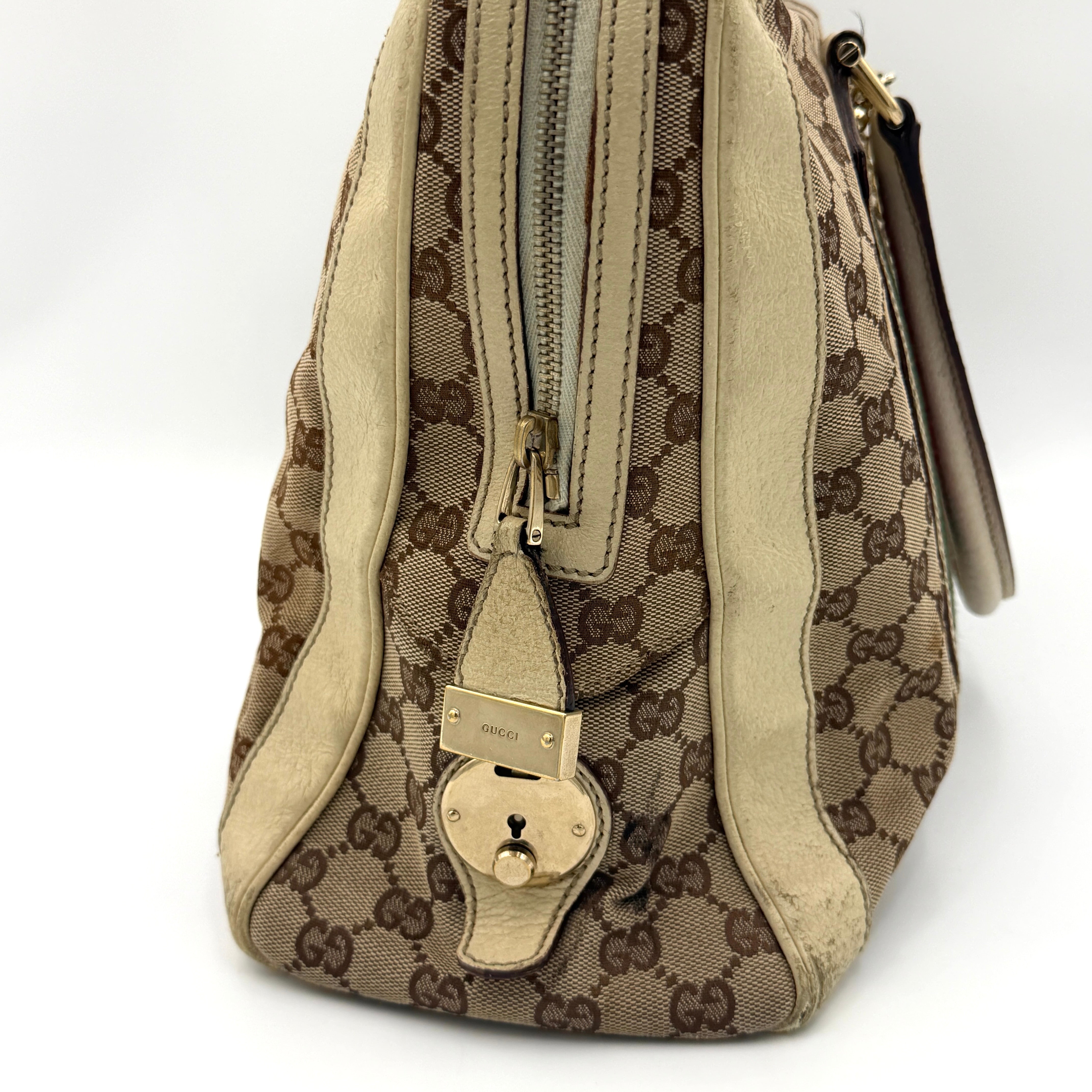 Gucci GG Monogram Stoffa Shoulder Bag in beige canvas with cream leather trim, iconic web stripes, and gold-tone chain detail.