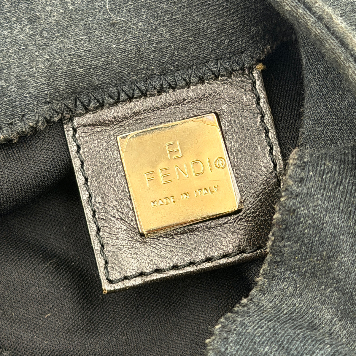 Fendi Mamma Baguette in grey textile with matte FF plaque, shown with original yellow Fendi dust bag.