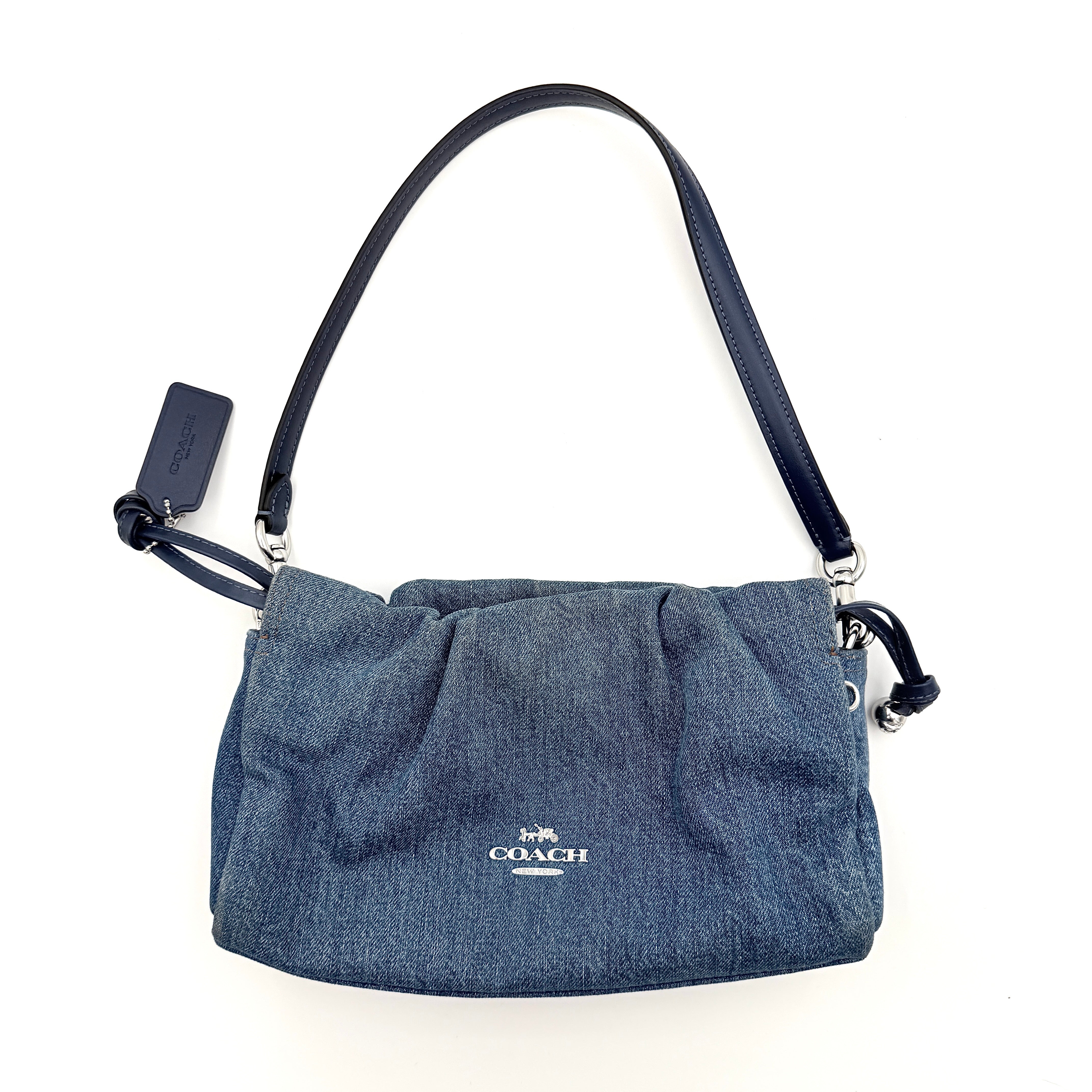 Coach Faye Shoulder Bag in blue denim with navy leather strap and detachable crossbody, styled simply against a white background.