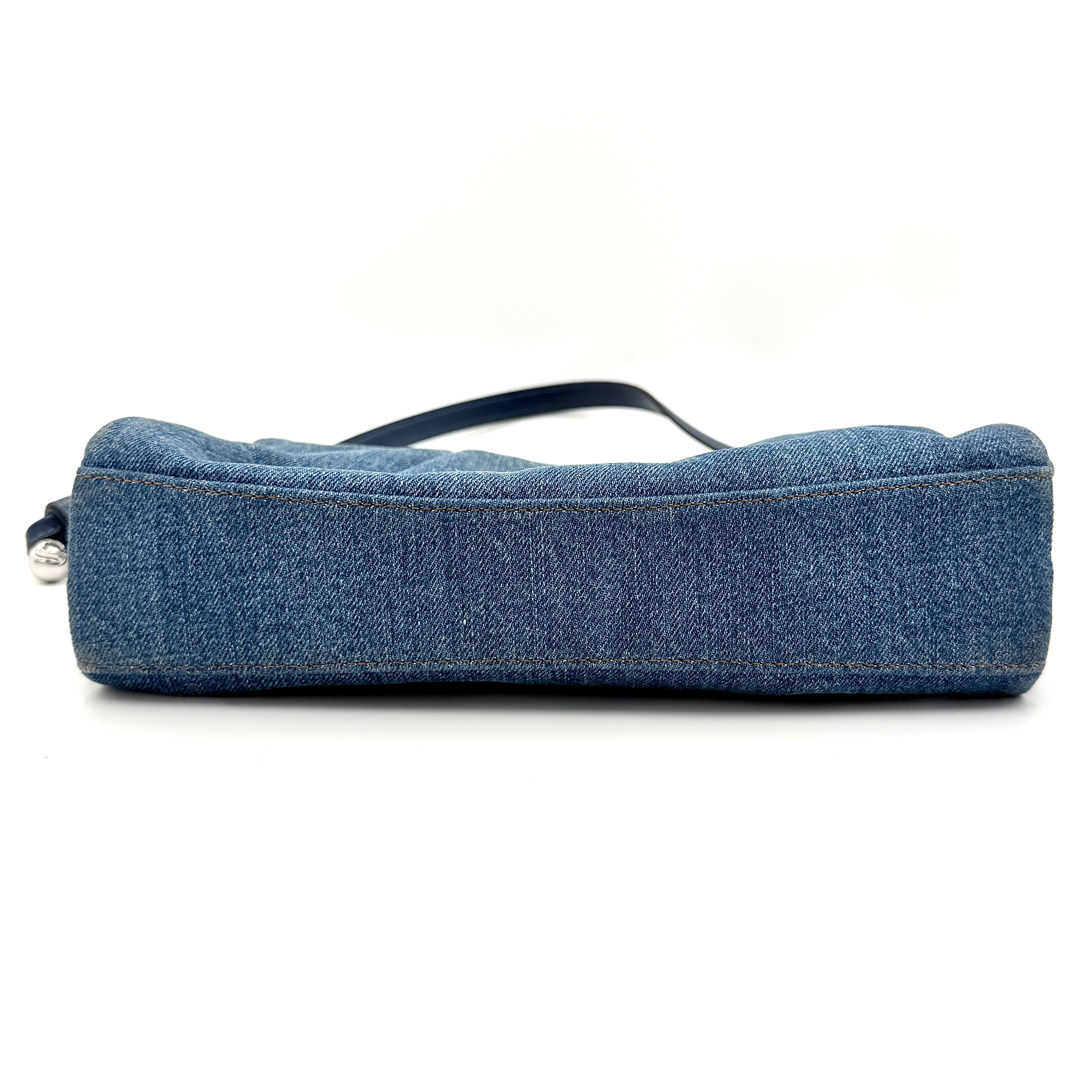 Coach Faye Shoulder Bag in blue denim with navy leather strap and detachable crossbody, styled simply against a white background.