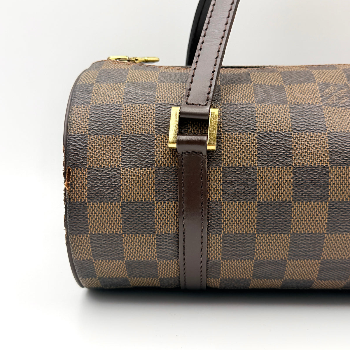 Louis Vuitton Damier Ebene Papillon 26 handbag in brown checked canvas with chocolate leather handles and gold hardware against a white background.