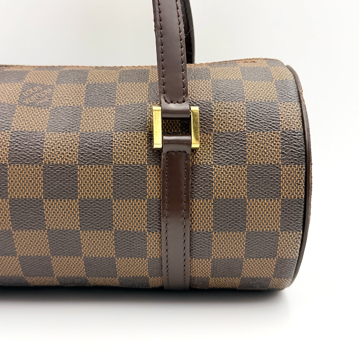 Louis Vuitton Damier Ebene Papillon 26 handbag in brown checked canvas with chocolate leather handles and gold hardware against a white background.