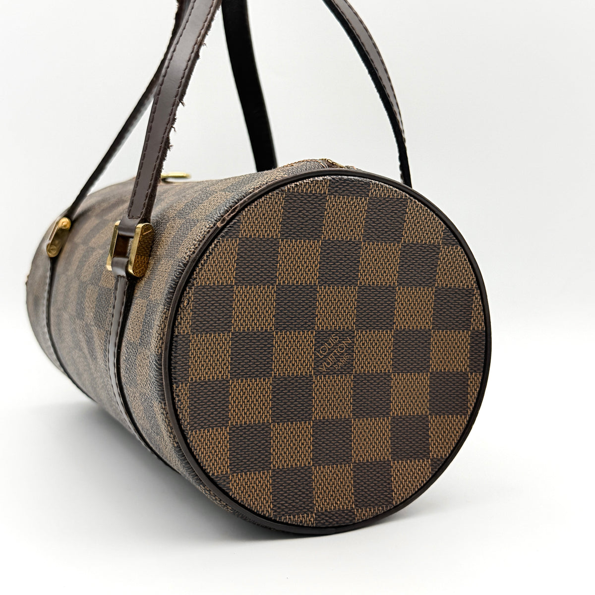 Louis Vuitton Damier Ebene Papillon 26 handbag in brown checked canvas with chocolate leather handles and gold hardware against a white background.