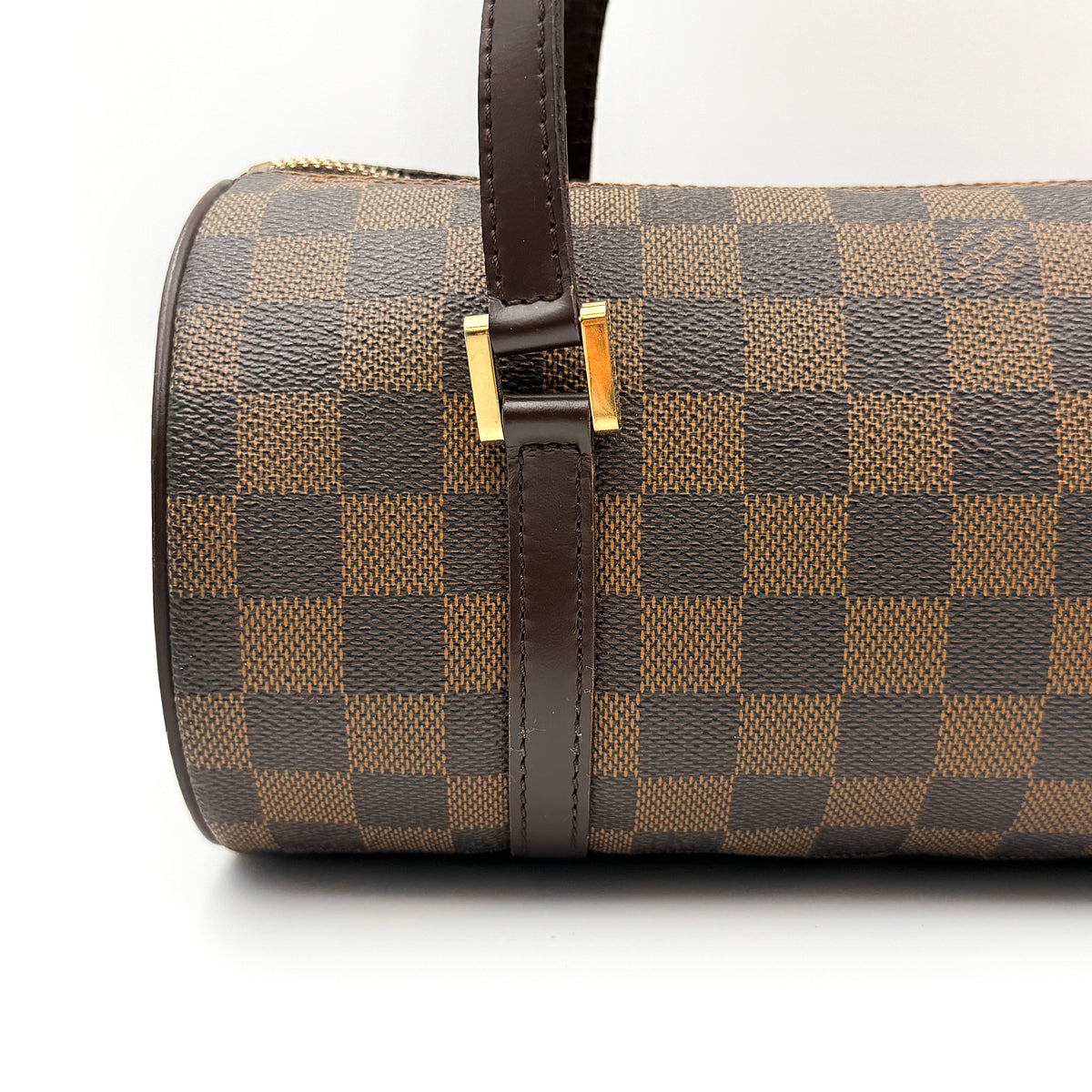 Louis Vuitton Damier Ebene Papillon 26 handbag in brown checked canvas with chocolate leather handles and gold hardware against a white background.