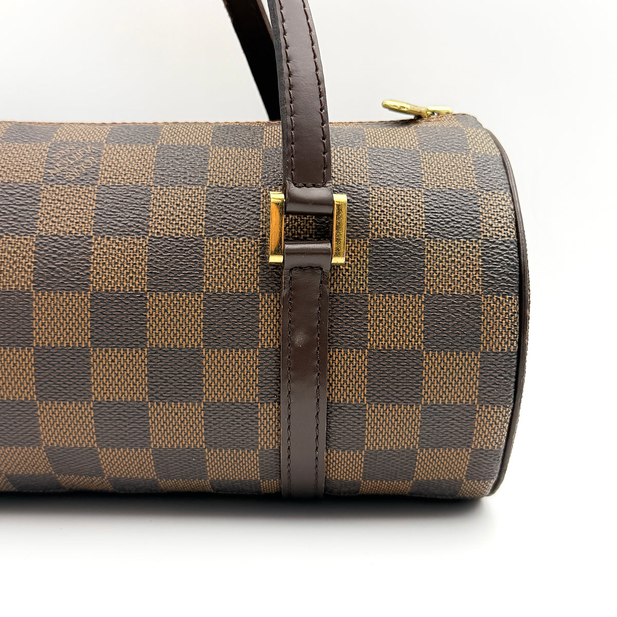 Louis Vuitton Damier Ebene Papillon 26 handbag in brown checked canvas with chocolate leather handles and gold hardware against a white background.