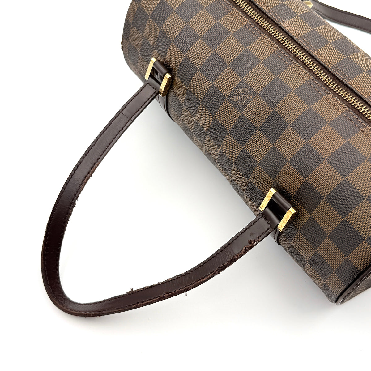 Louis Vuitton Damier Ebene Papillon 26 handbag in brown checked canvas with chocolate leather handles and gold hardware against a white background.