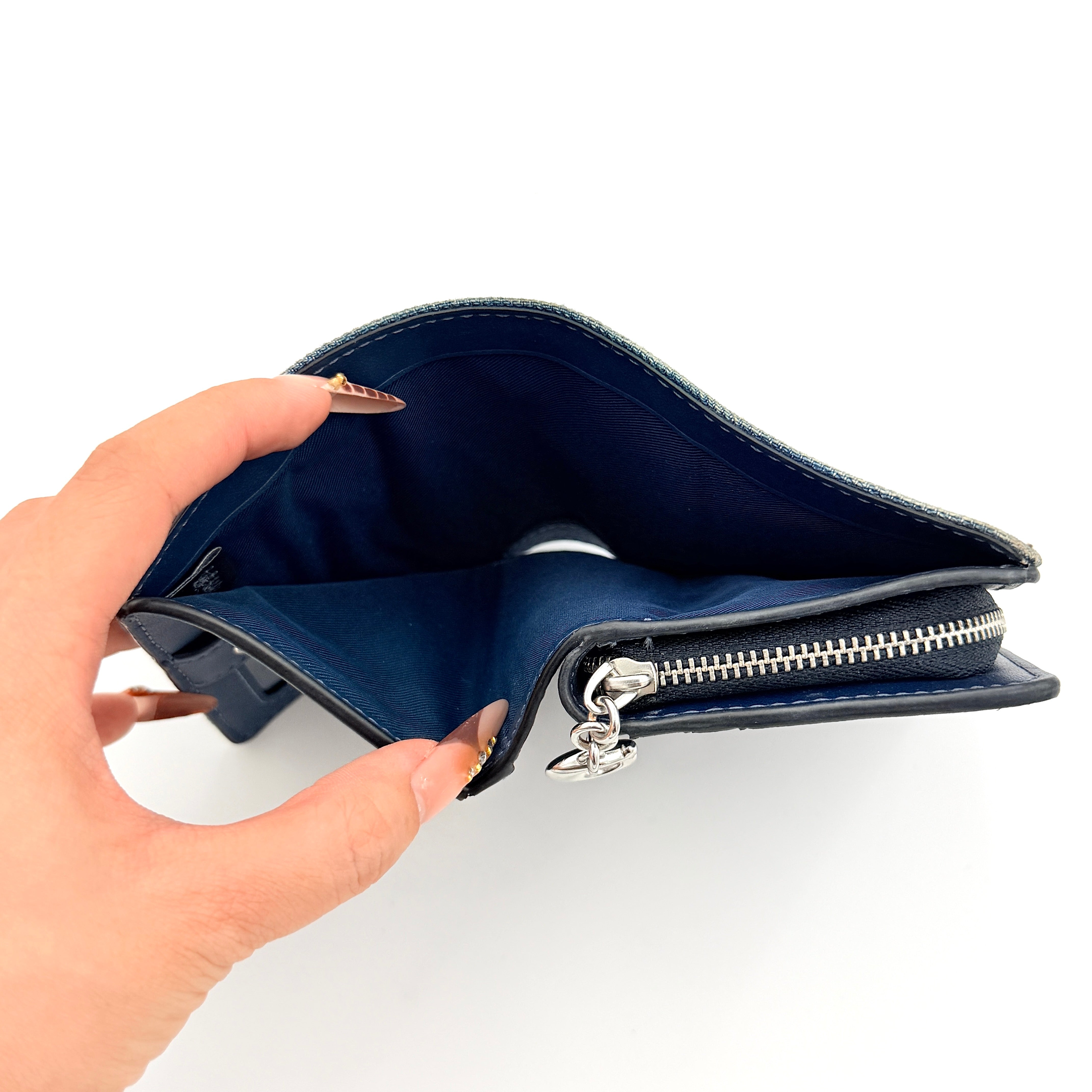 Coach Signature Snap Wallet in blue denim with silver-tone logo, shown closed from the front.