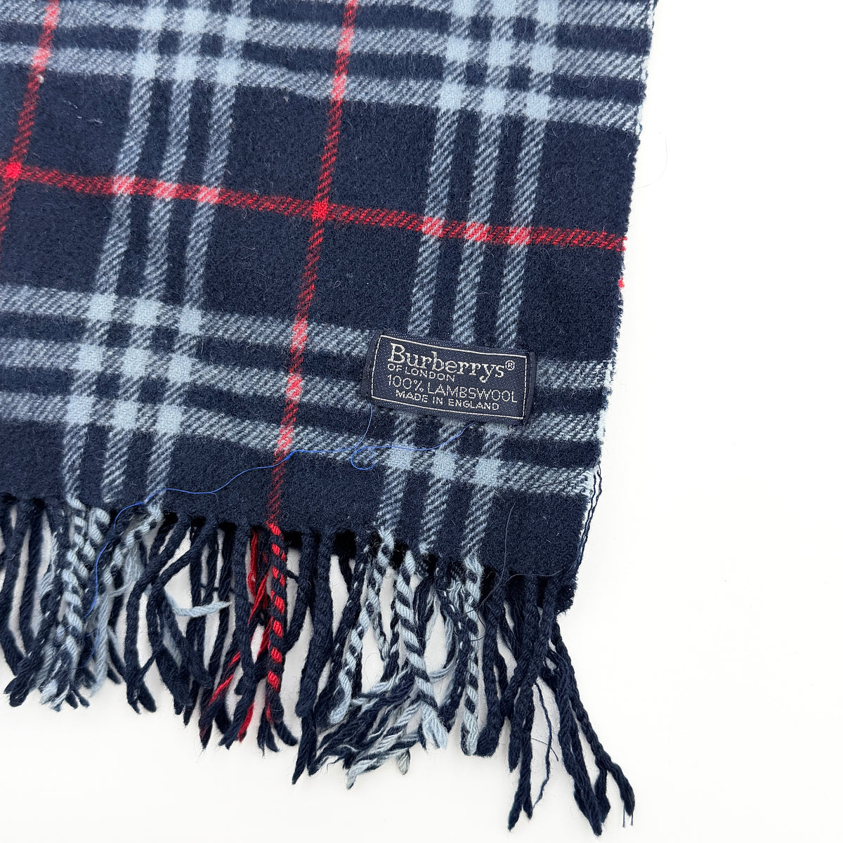 Burberrys navy Nova Check lambswool shawl scarf with tassel ends, shown folded against a white background.