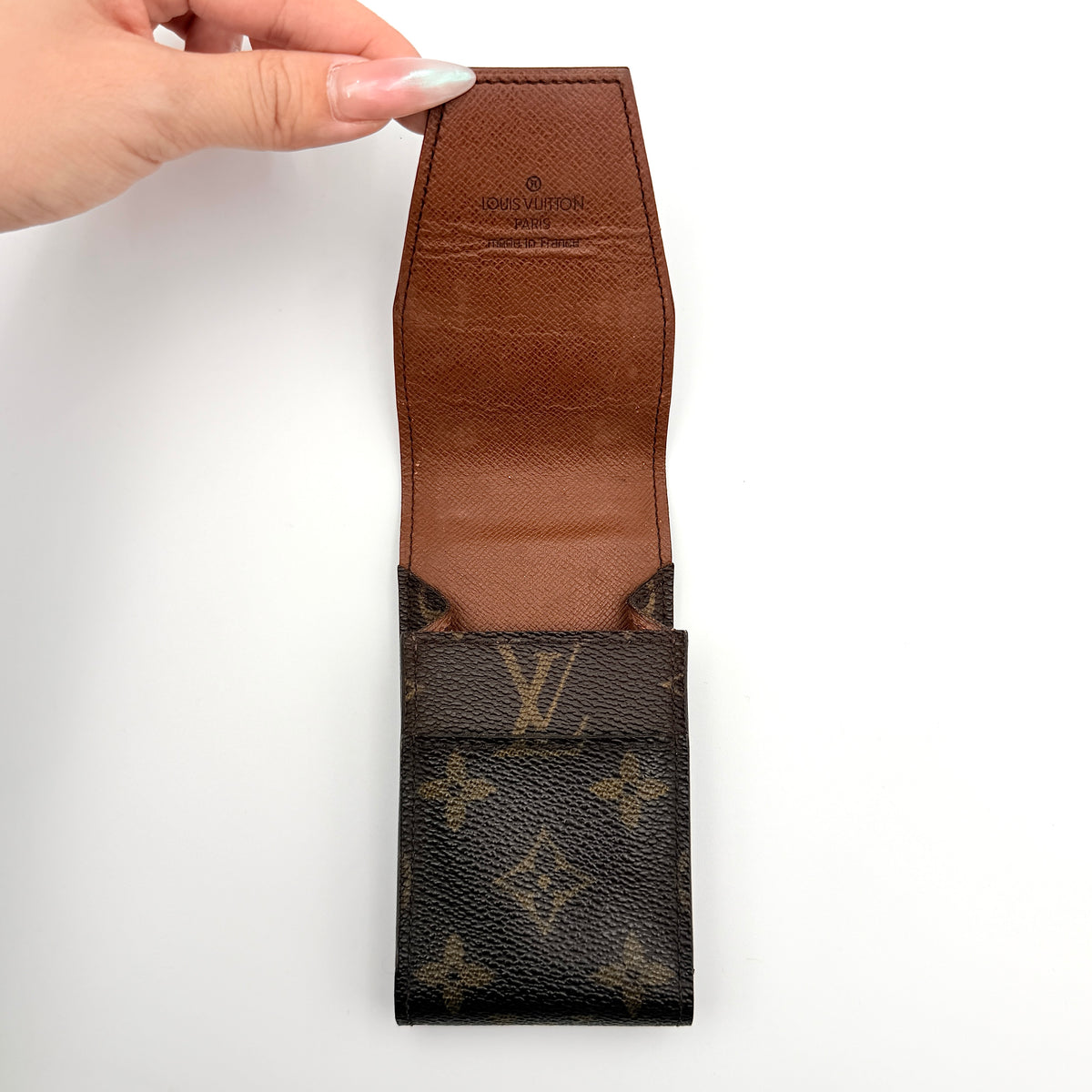 Louis Vuitton monogram brown cigarette case with flap closure on white background