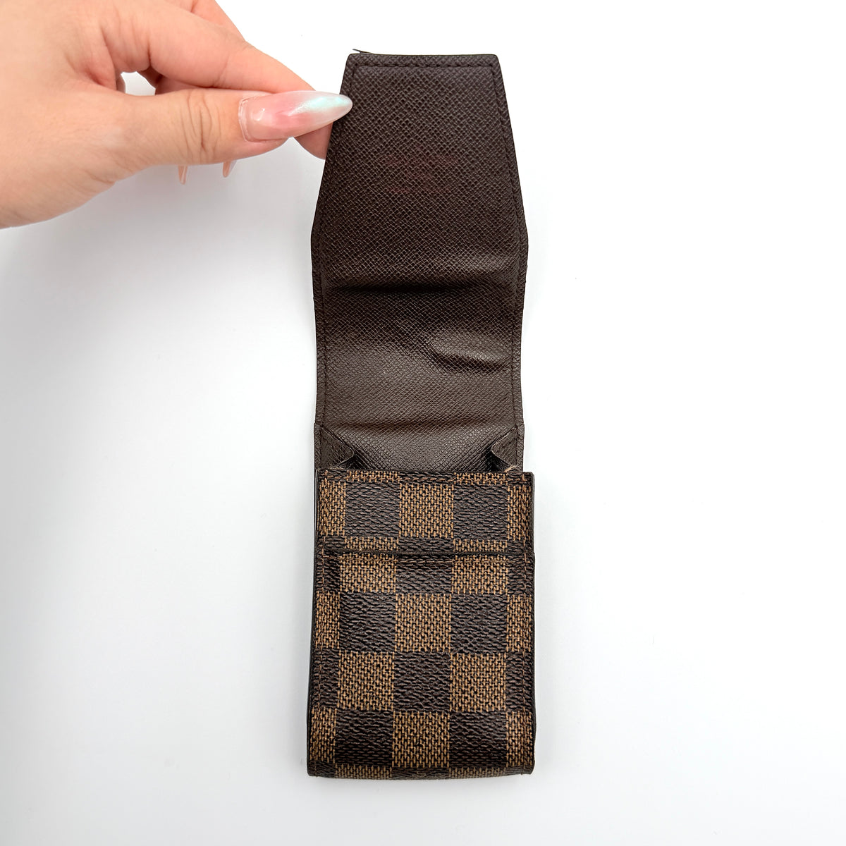 Louis Vuitton Damier brown cigarette case in checked coated canvas with a flap closure, photographed against a white background.