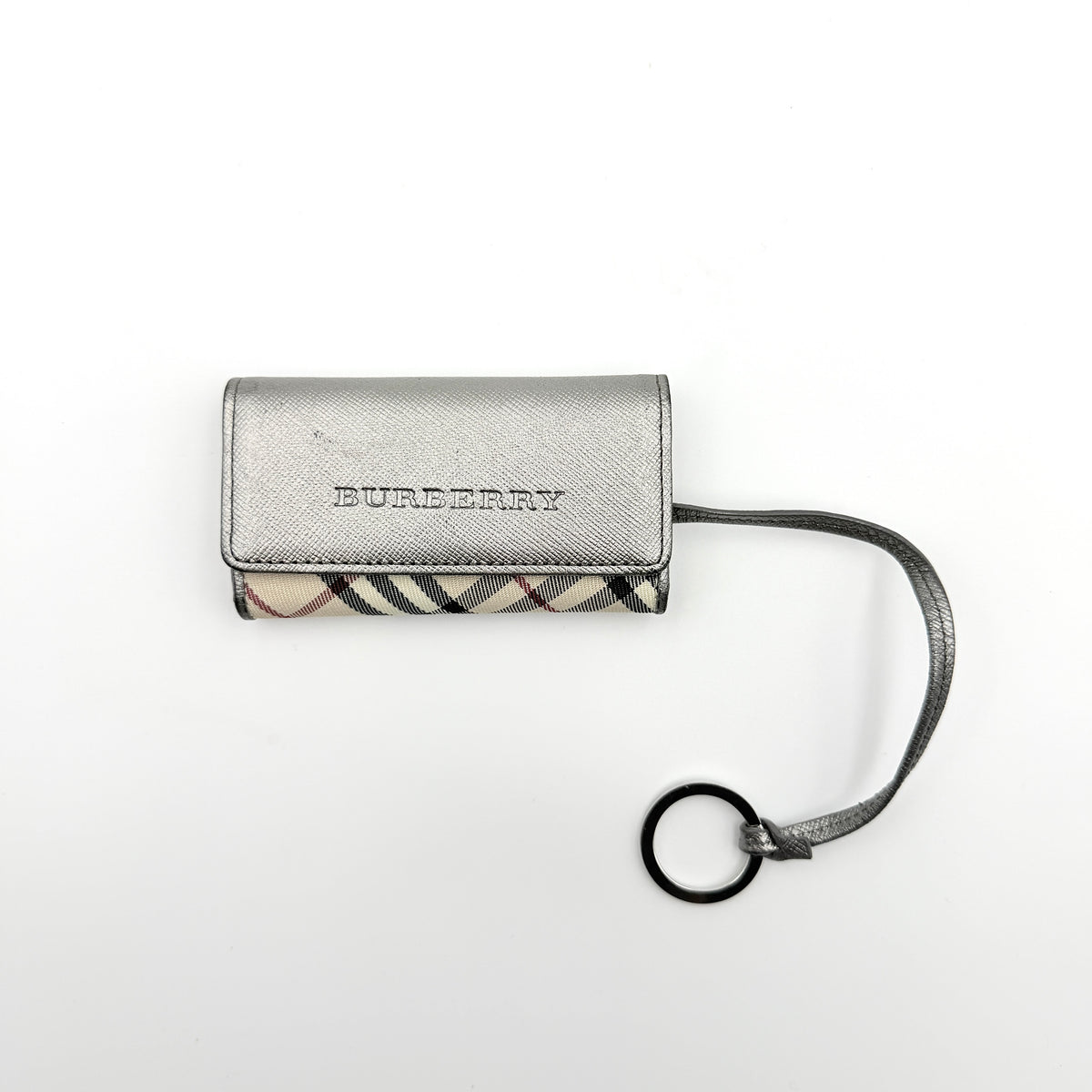 Burberry Nova Check key case in metallic silver leather and beige check canvas with key ring and snap closure.
