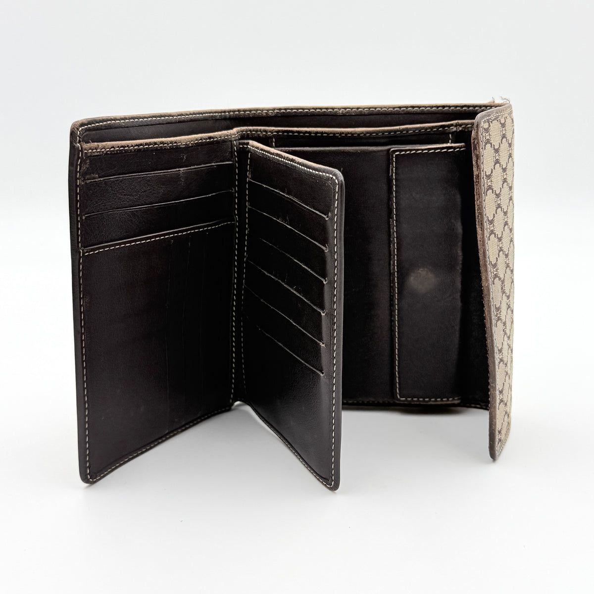 Celine Macadam Monogram Trifold Wallet in brown coated canvas with all-over motif, photographed closed on a white background