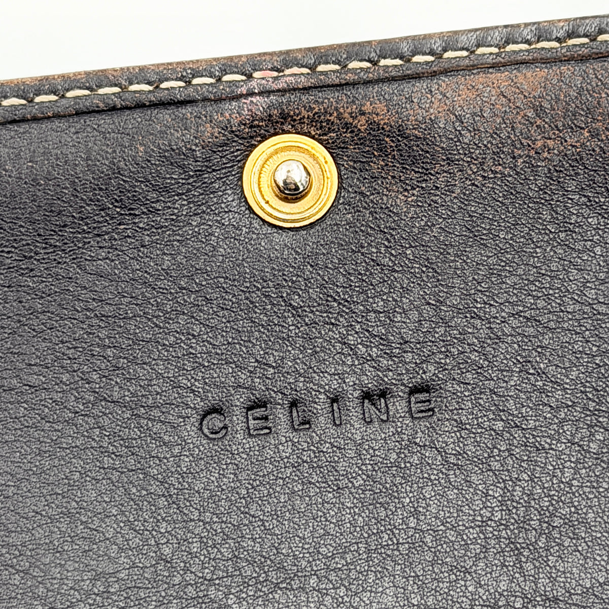 Celine Macadam Monogram Trifold Wallet in brown coated canvas with all-over motif, photographed closed on a white background