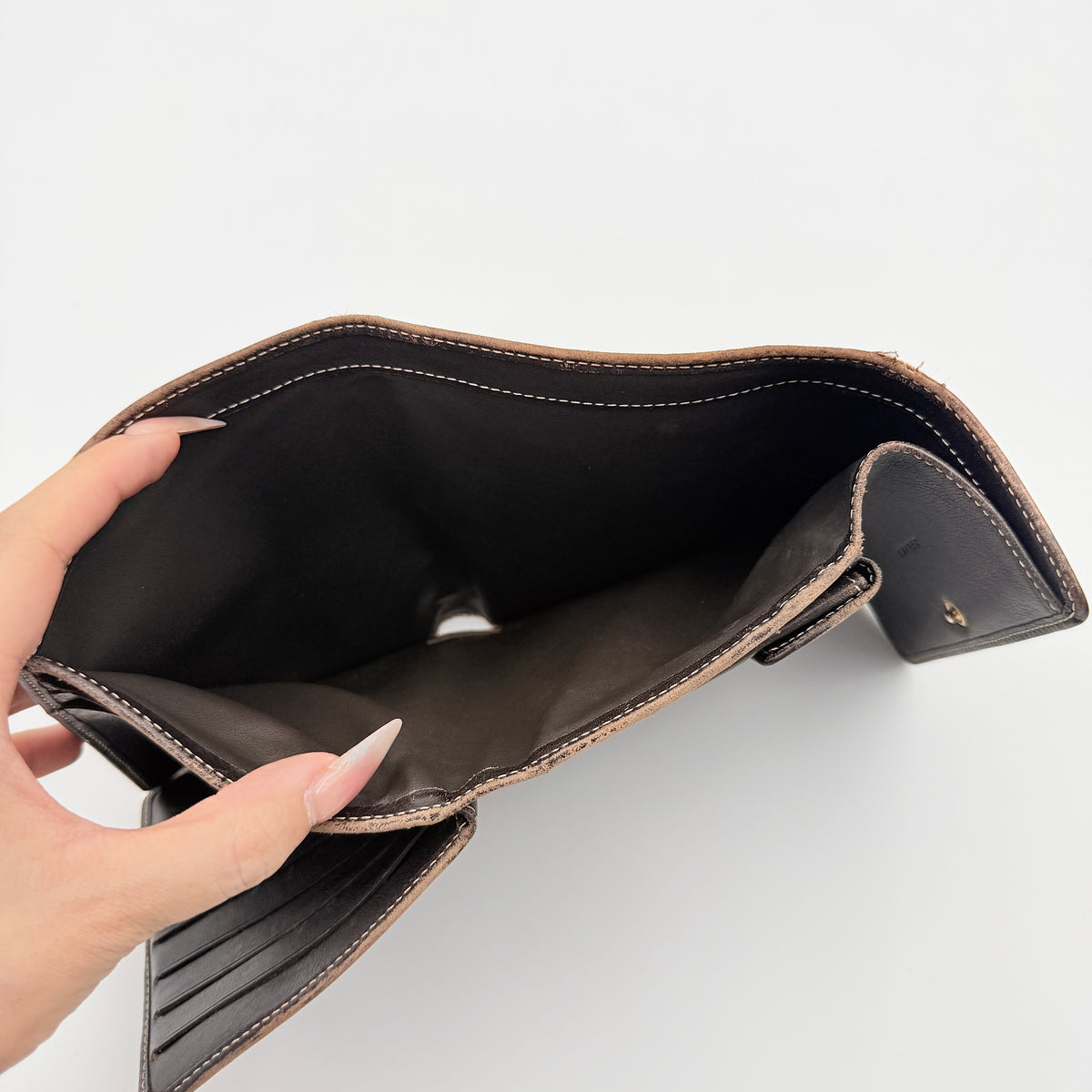 Celine Macadam Monogram Trifold Wallet in brown coated canvas with all-over motif, photographed closed on a white background